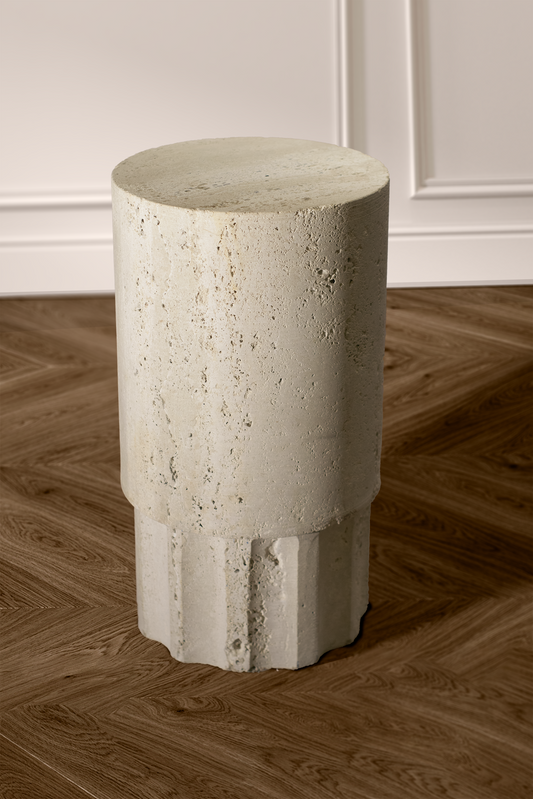 Heritage Travertine Side Table handcrafted from natural stone featuring a sculptural cylindrical base and round top.