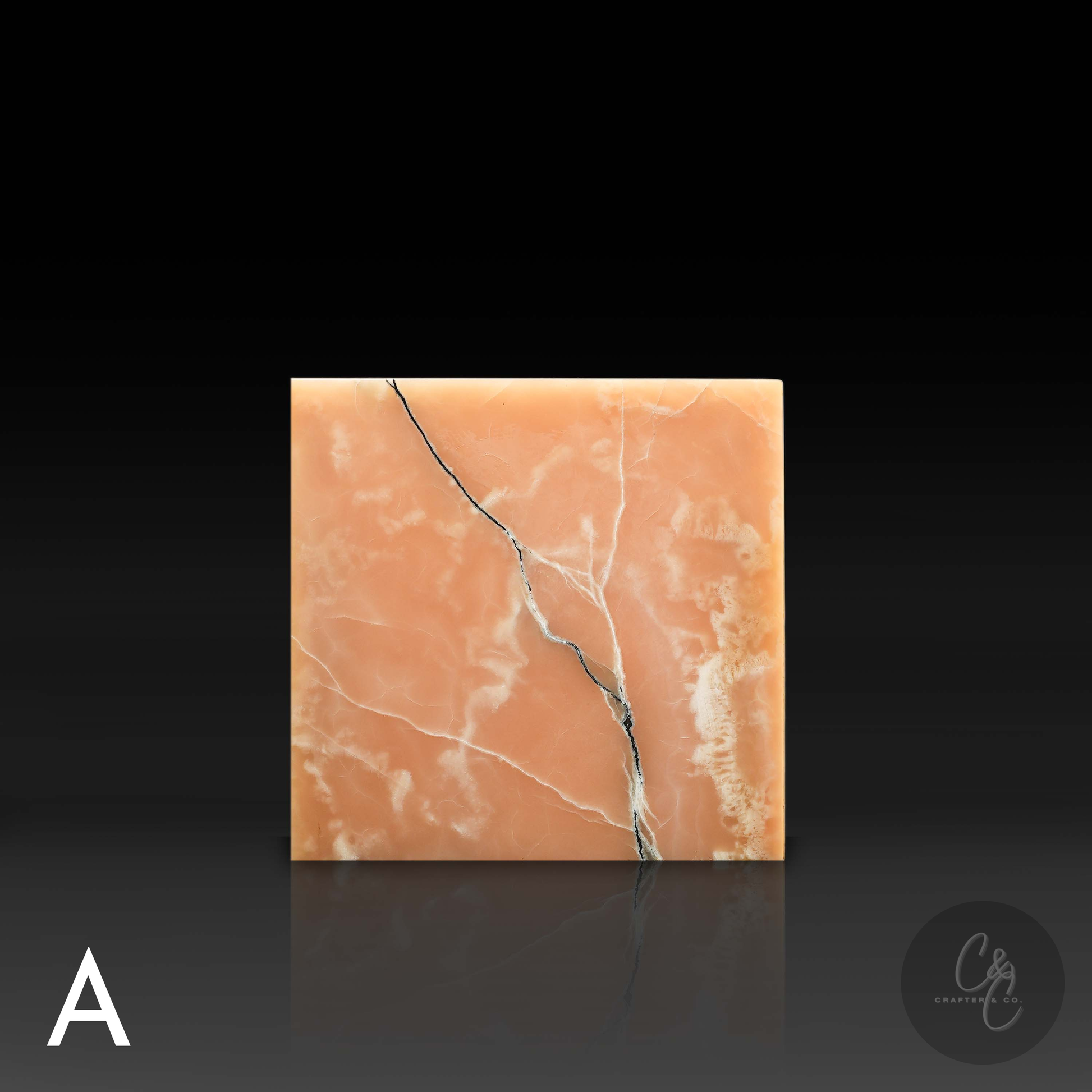 Front profile of a Honey Onyx cube side table featuring warm amber tones and dramatic natural black veining