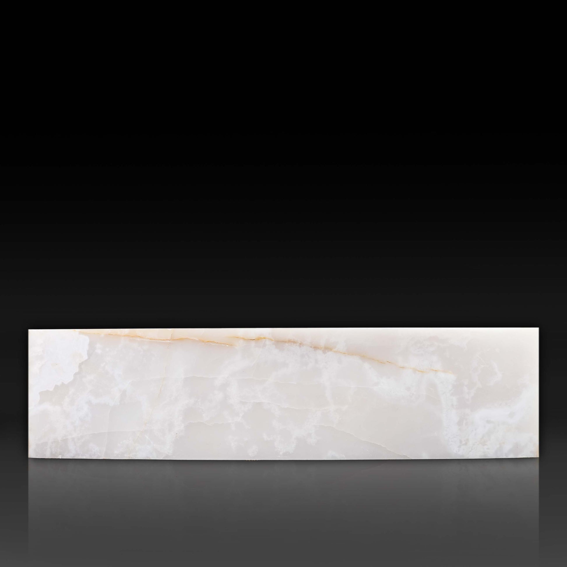 Front profile of large White Onyx block coffee table with polished natural stone finish.