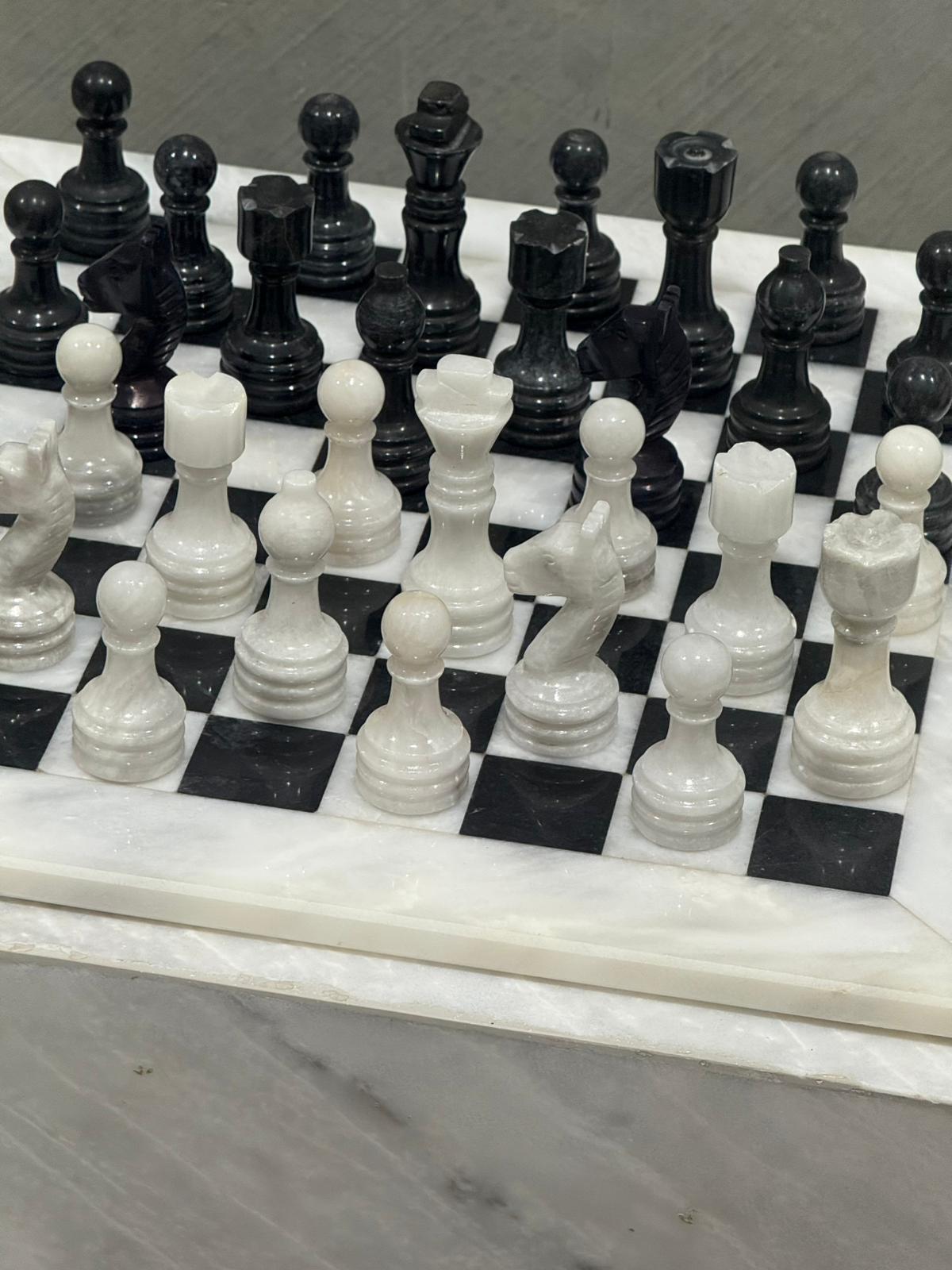 Black and white marble chess set displayed as designer home décor