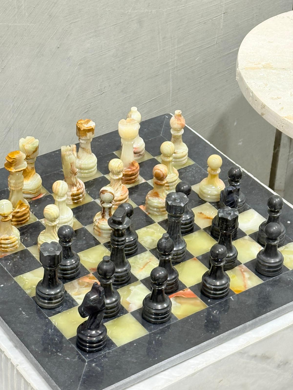 Chessboard with pieces on a gray surface
