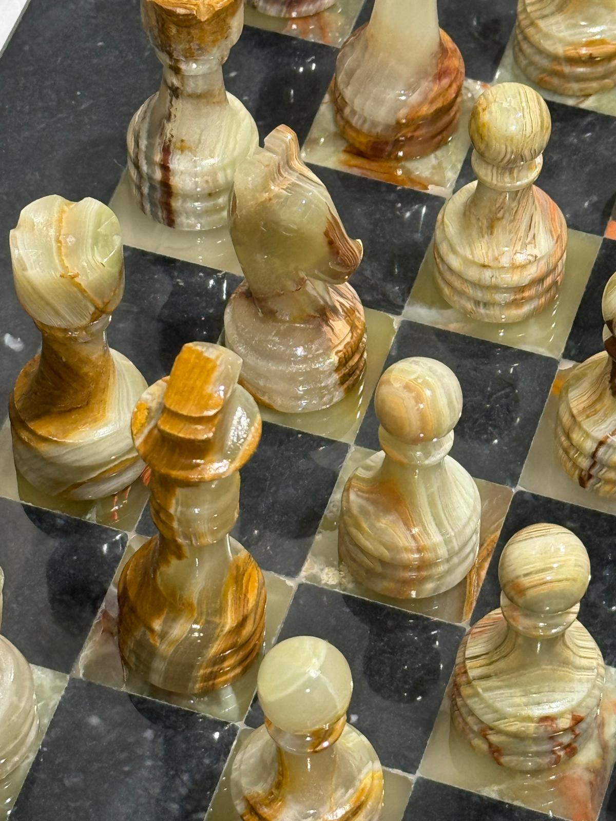 Marble chess pieces on a checkered board