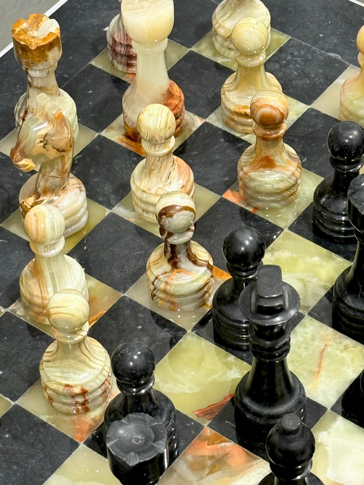 Marble chess pieces on a checkered board details.