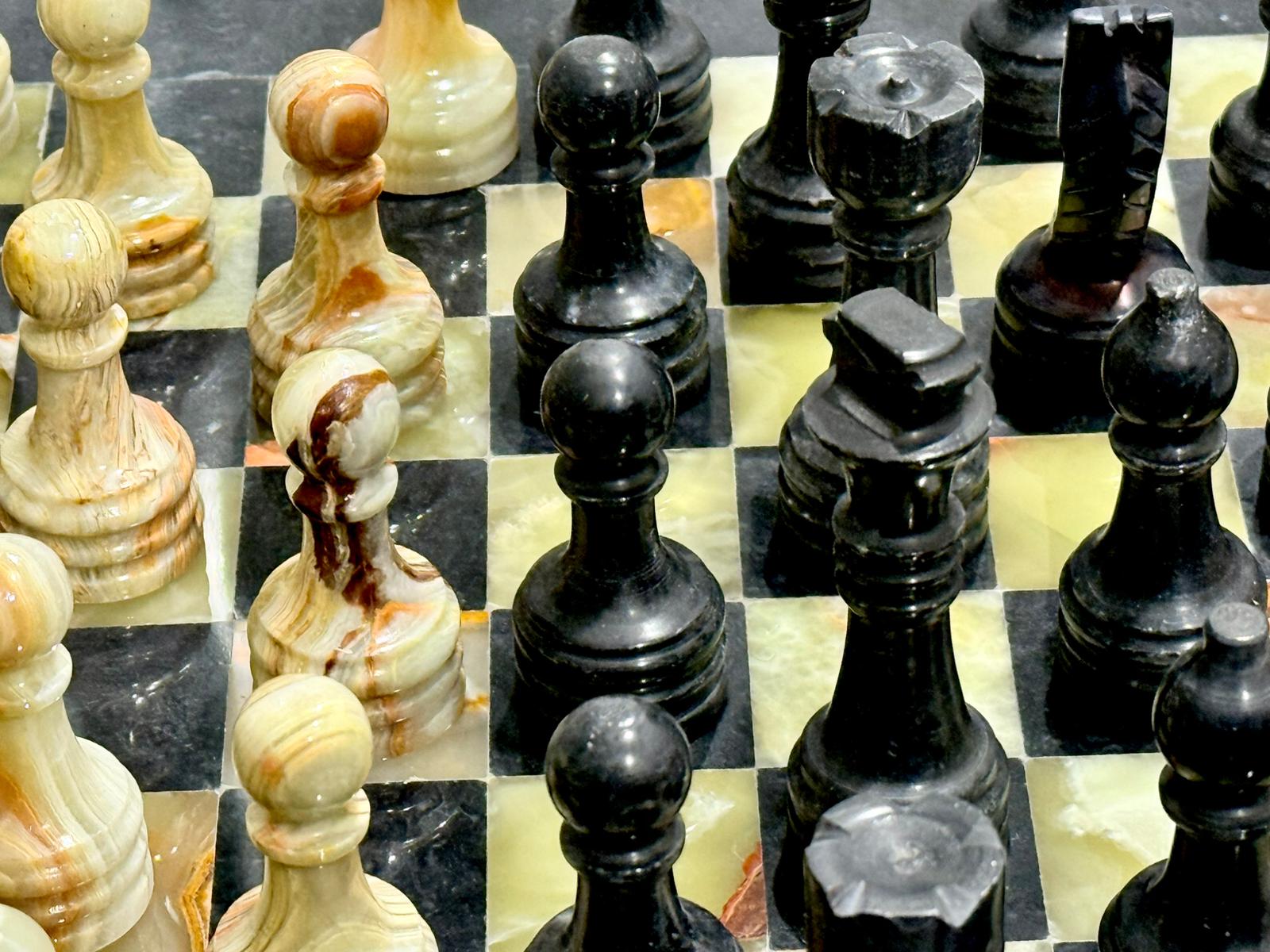 Close up of Hand carved Green Onyx and Black Marble chess pieces