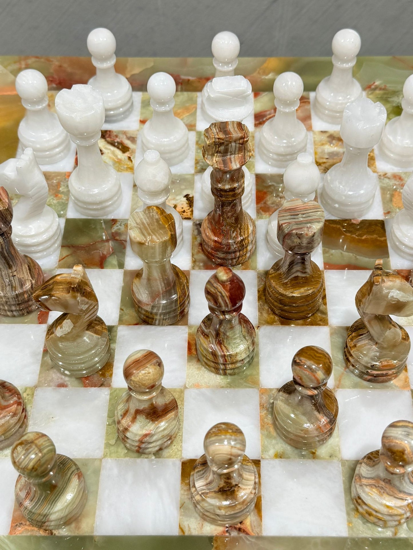 Close-up of handcrafted Green Onyx and White Marble chess pieces