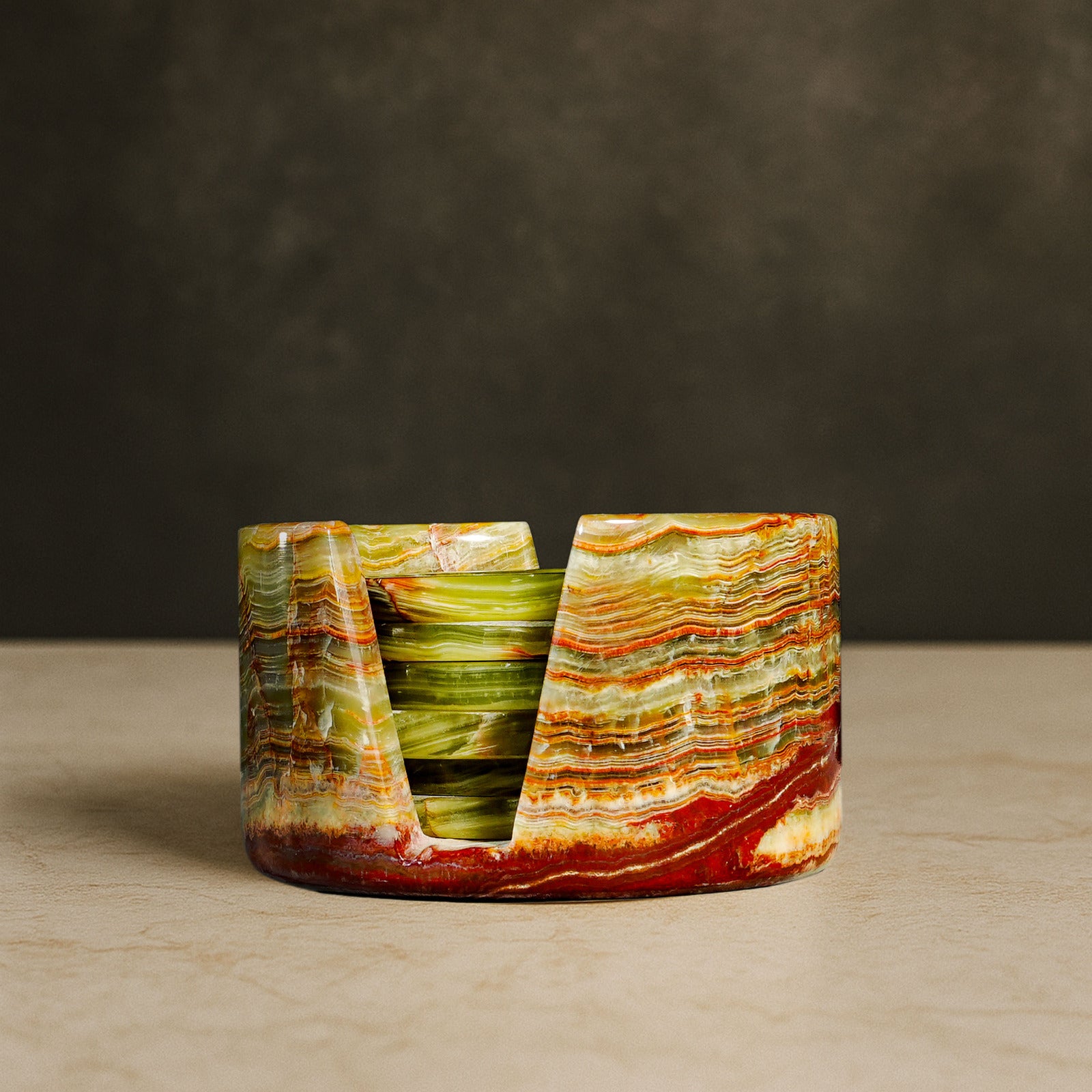 Murmor natural stone coasters set with holder in Green Onyx displayed on a stone surface.