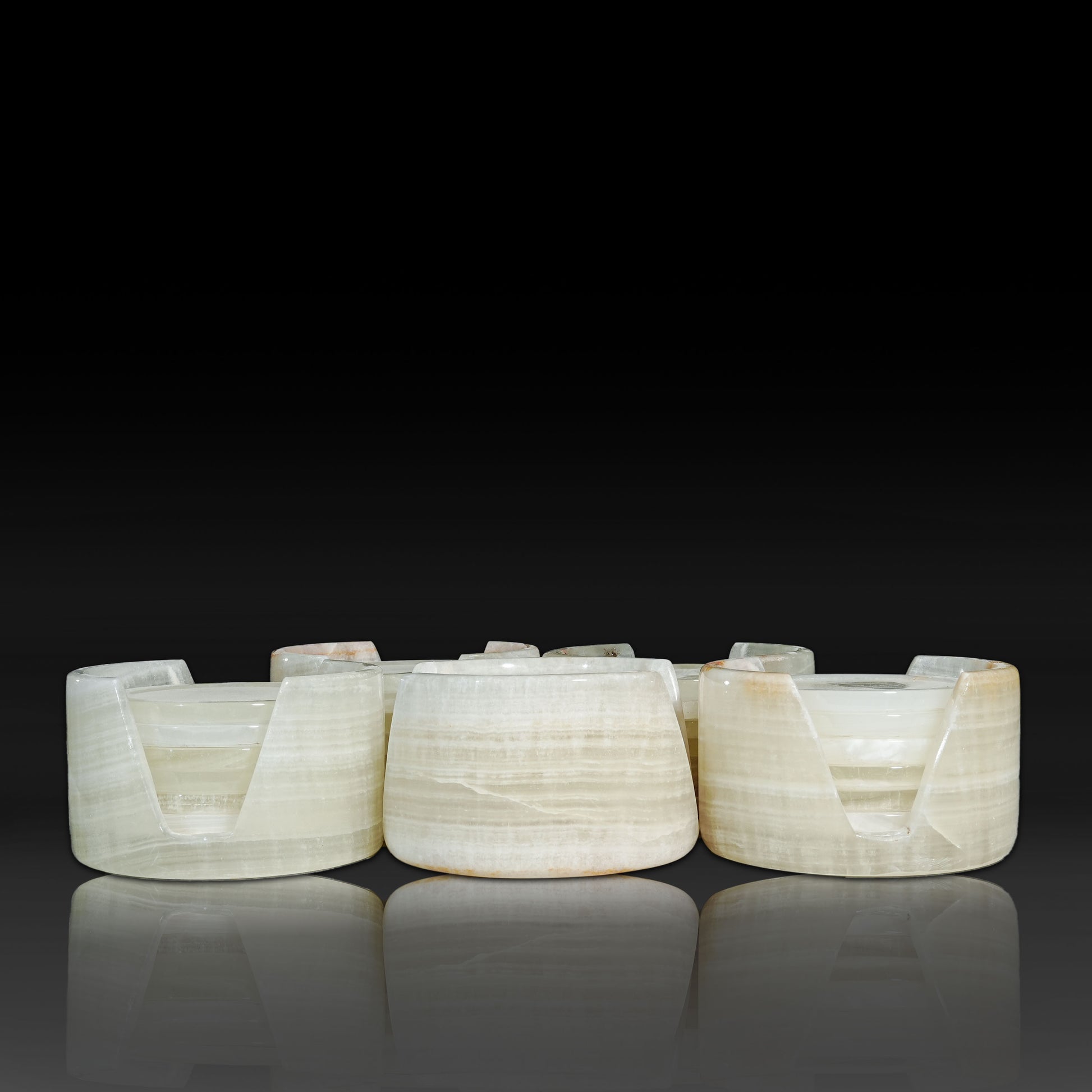 Group of Murmor White Onyx natural stone coasters sets with matching holders.