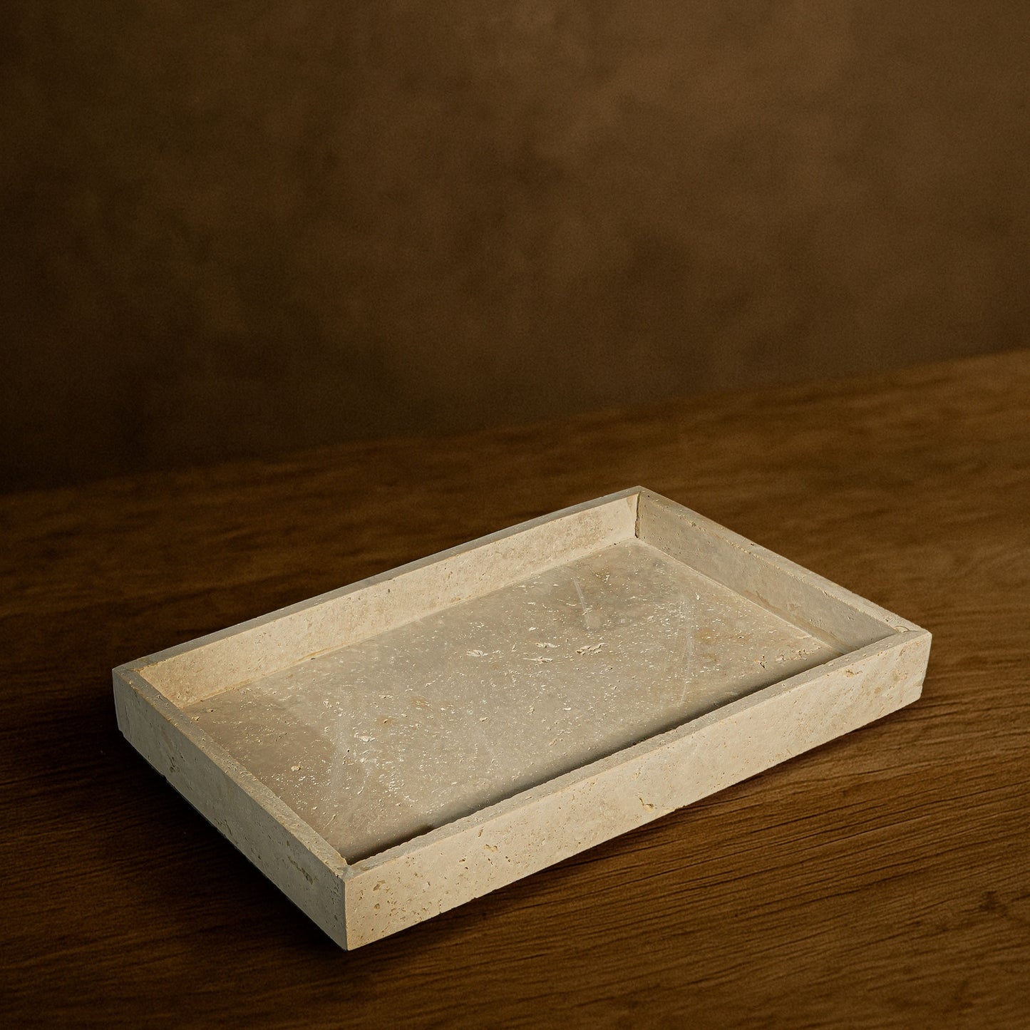 Front angle of the Oblong Travertine Tray showcasing its natural stone texture.
