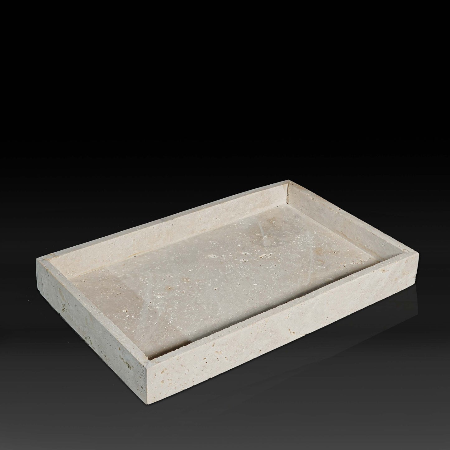 Oblong Travertine Tray with thin edge handcrafted from natural travertine shown from a front angle.
