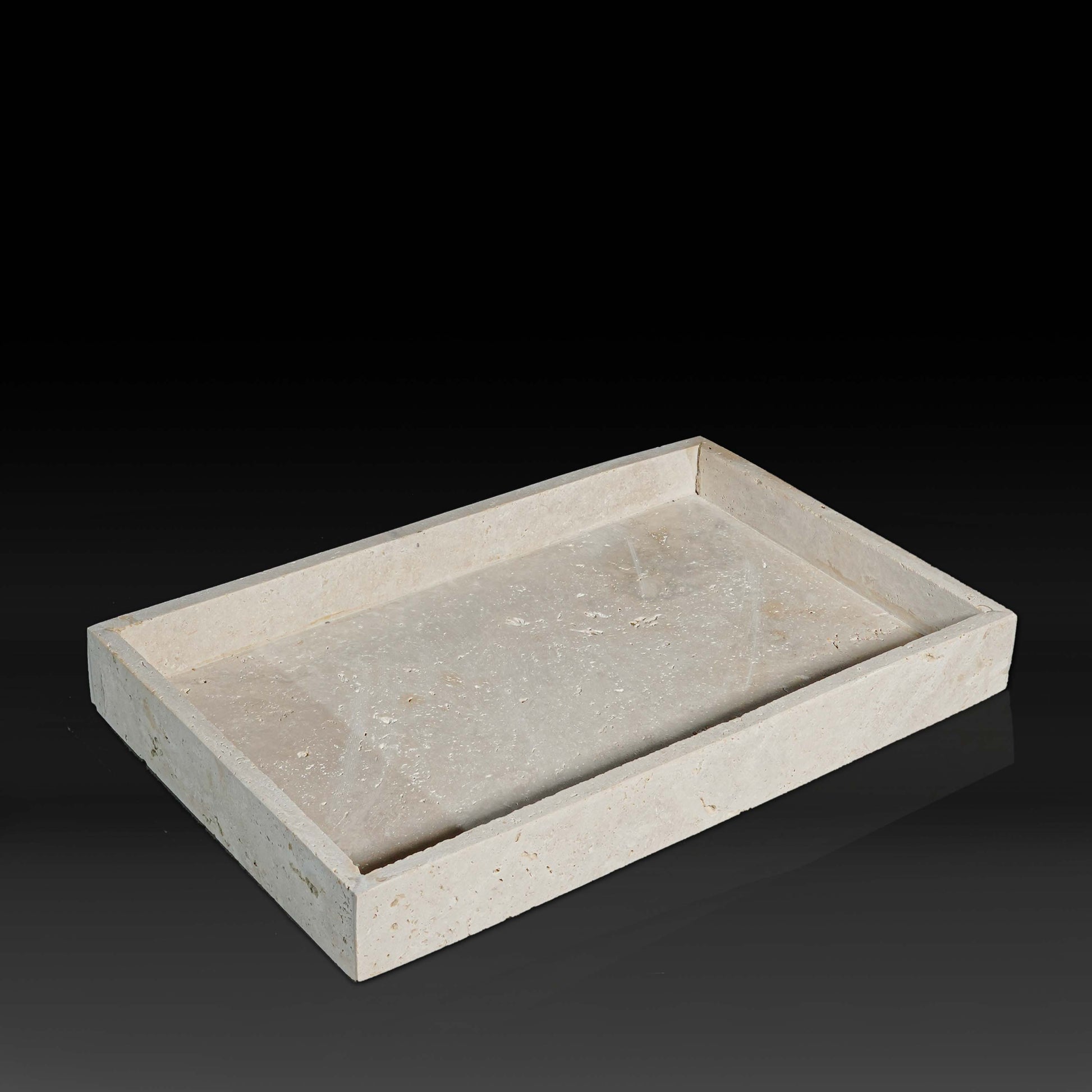 Oblong Travertine Tray with thin edge handcrafted from natural travertine shown from a front angle.