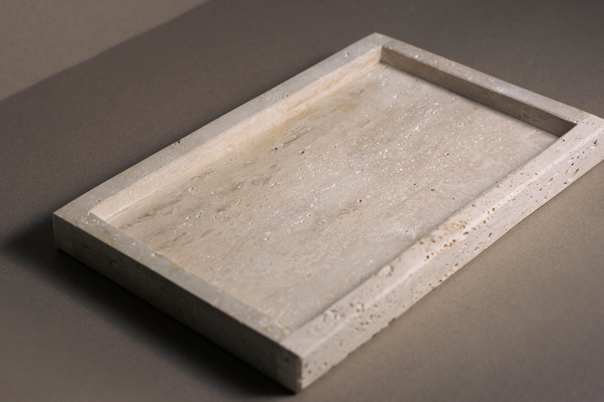 Top view of the Oblong Travertine Tray highlighting the natural travertine surface.