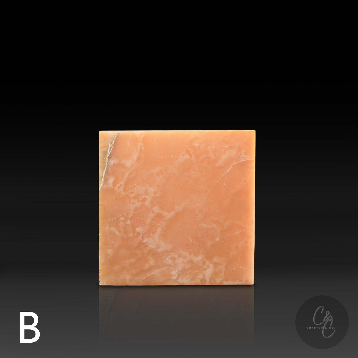 Orange onyx cube side table variation B shown from the front, featuring unique natural veining.