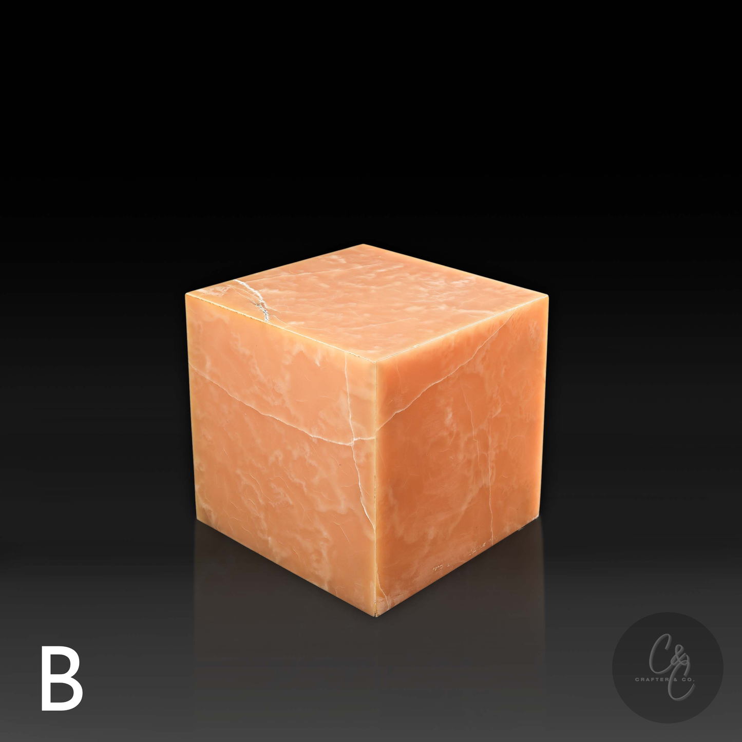 Orange onyx cube side table variation B shown from a top angle, highlighting its natural veining.