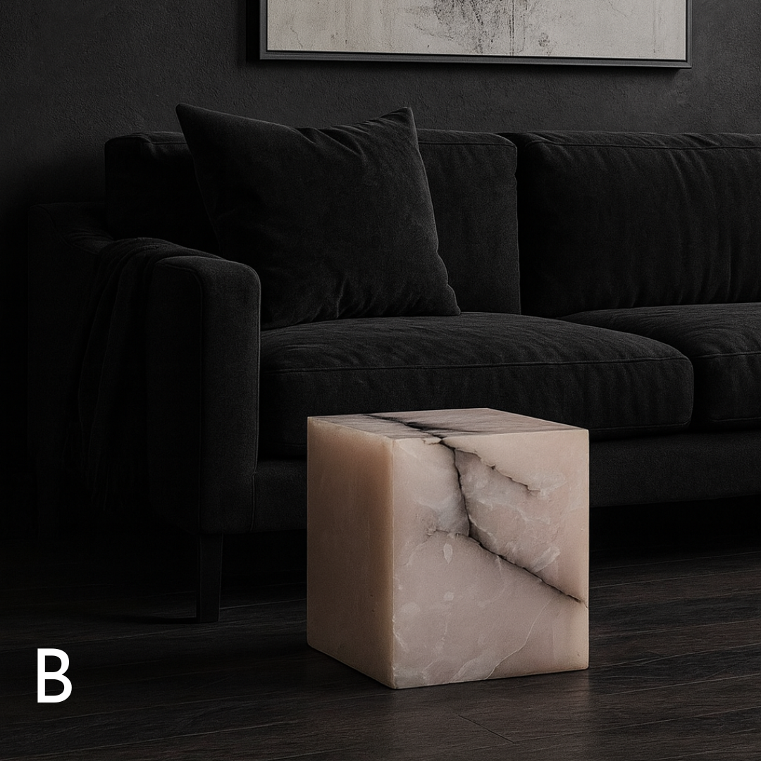 Pink onyx cube side table variation B styled in front of a black sofa in a dark contemporary living room.