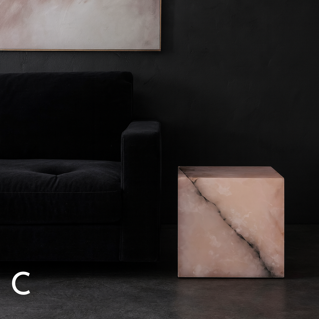 Pink onyx cube side table variation C styled beside a black armchair in a dark contemporary living room.