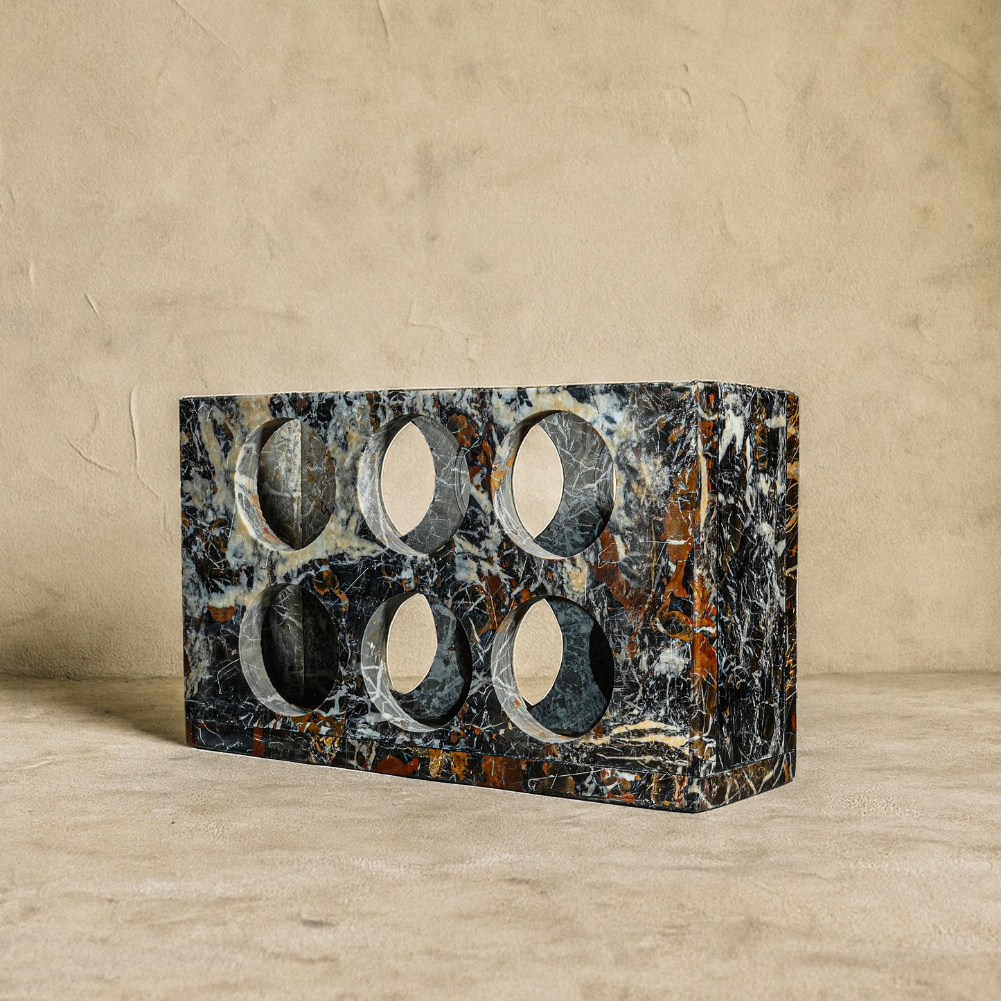 Front angle view of Quadrant Black and Gold Marble wine rack crafted from natural polished marble.