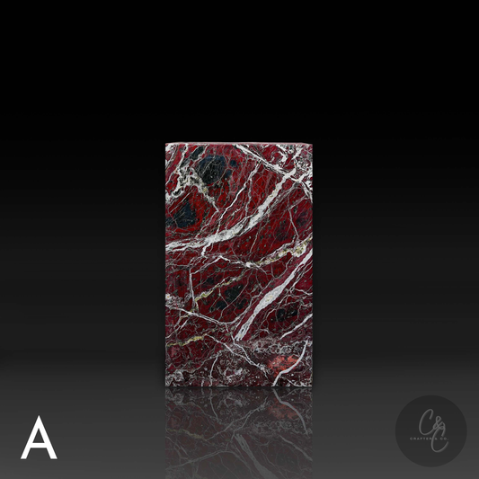Front view of Rosso Levanto marble column side table showcasing rich natural veining and sculptural design.