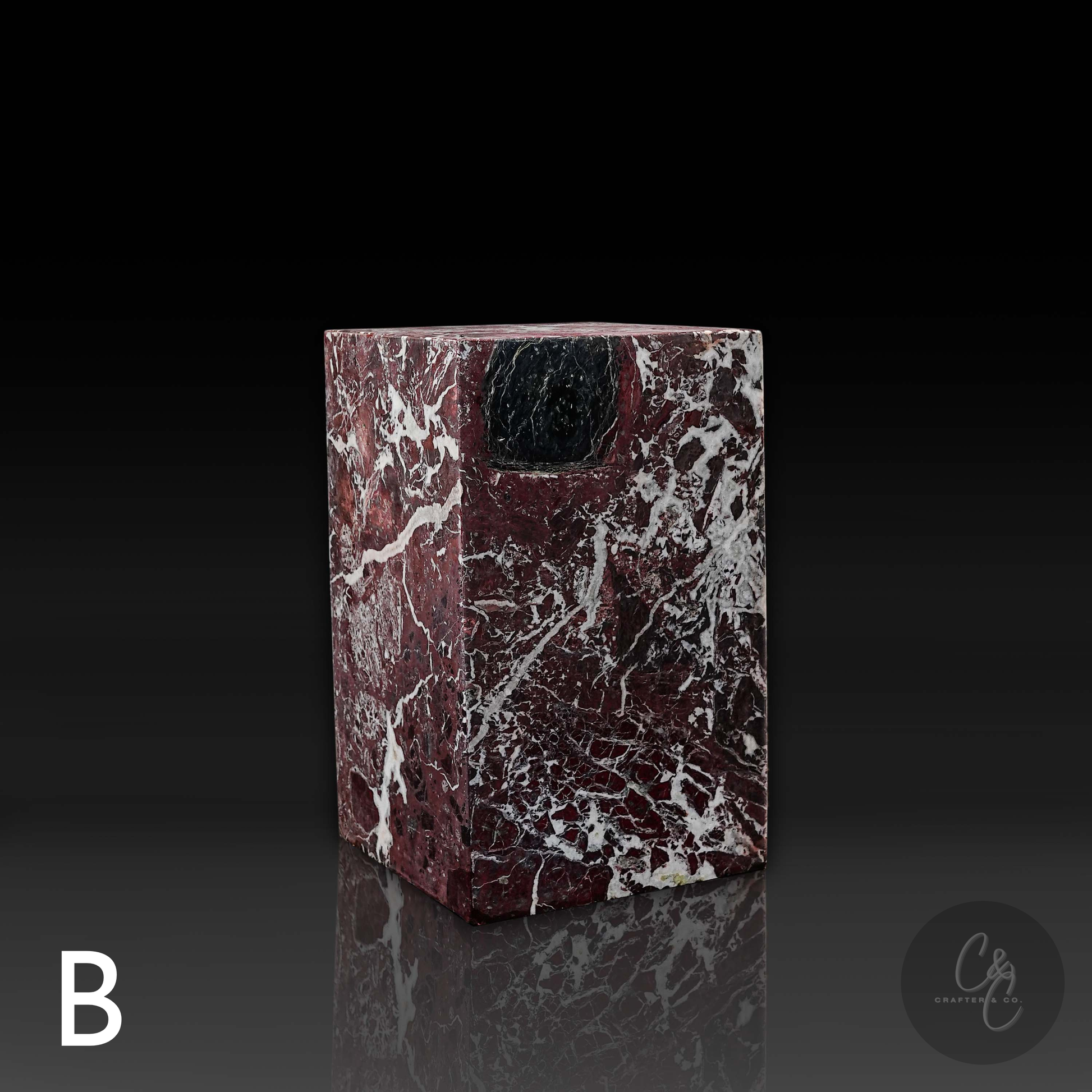 Front profile of a handcrafted Rosso Levanto marble column side table showcasing dramatic natural stone movement.