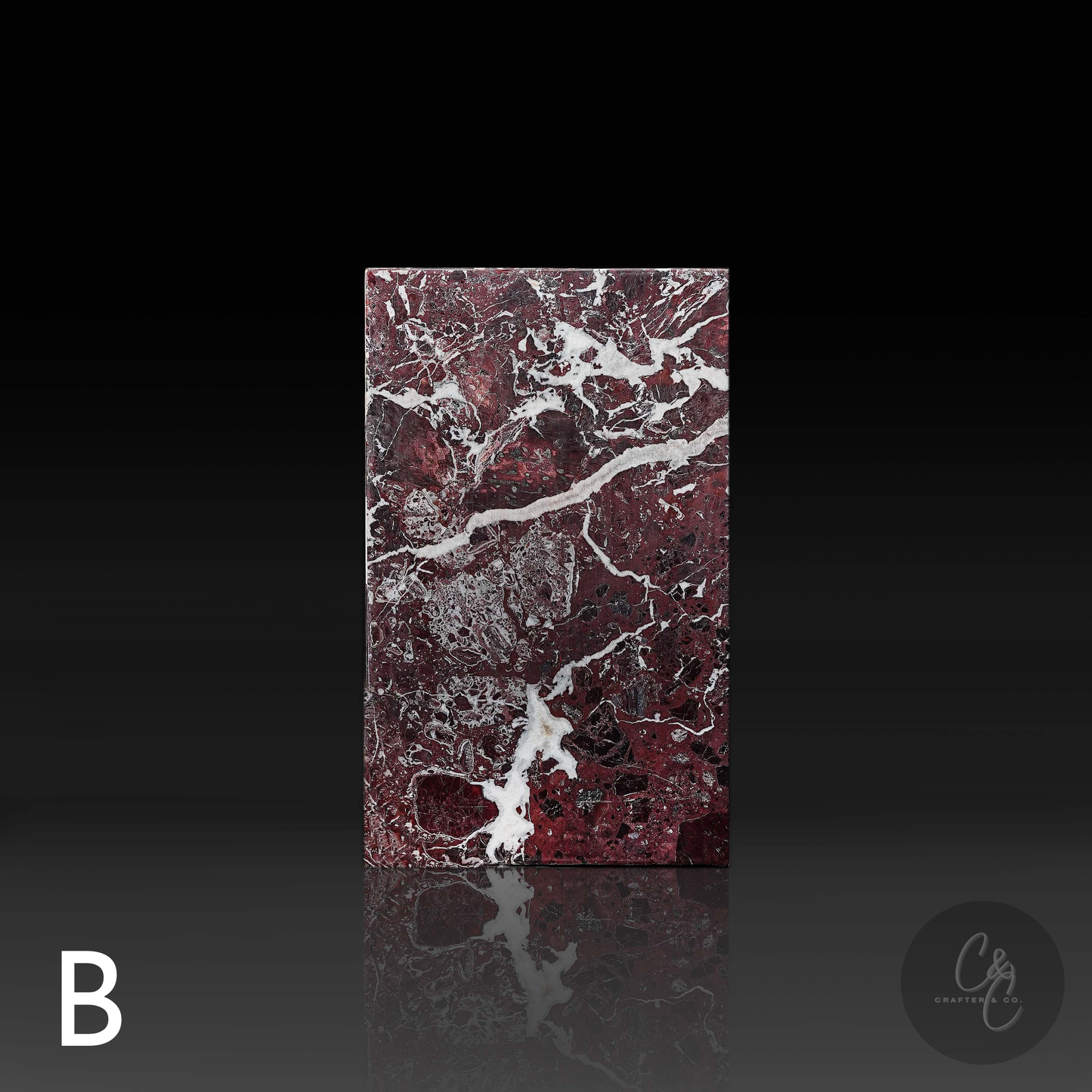 Straight front view of Rosso Levanto marble side table highlighting rich burgundy marble with striking white veining.