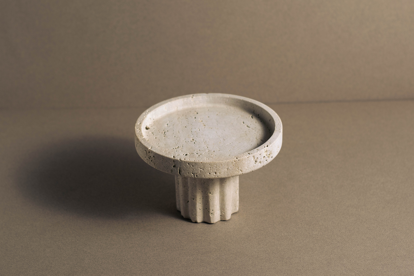 Round Travertine Pedestal Tray styled as a luxury decorative tray for bathroom vanity and home décor.
