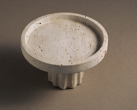 Round Travertine Pedestal Tray viewed from a top angle showcasing natural stone texture and pedestal base.