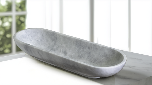 Luxury Serenity Oval White Marble Bowl displayed as a decorative centerpiece on a modern console table.