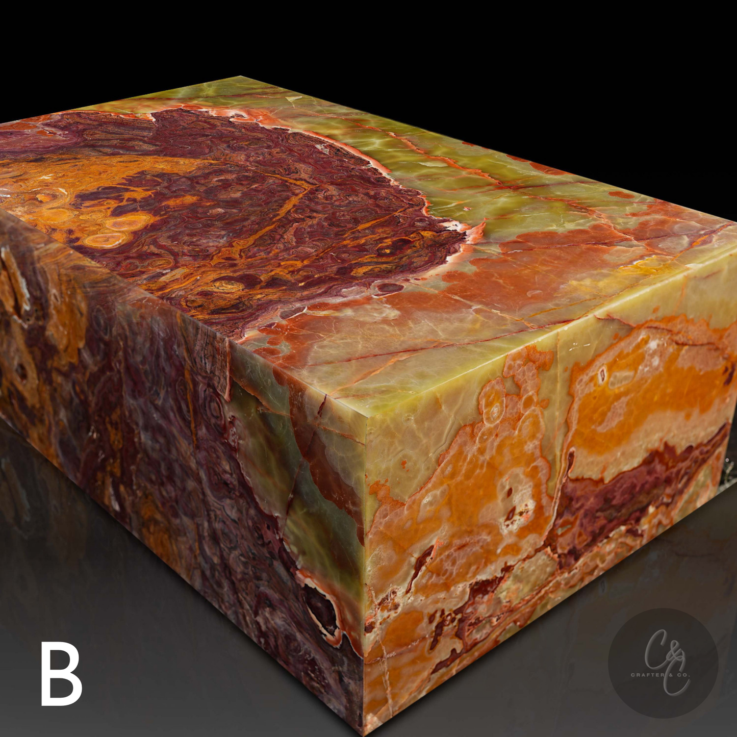 Angled view of Small Block Green Onyx Coffee Table B handcrafted from polished natural green onyx with bold green rust amber and cream veining