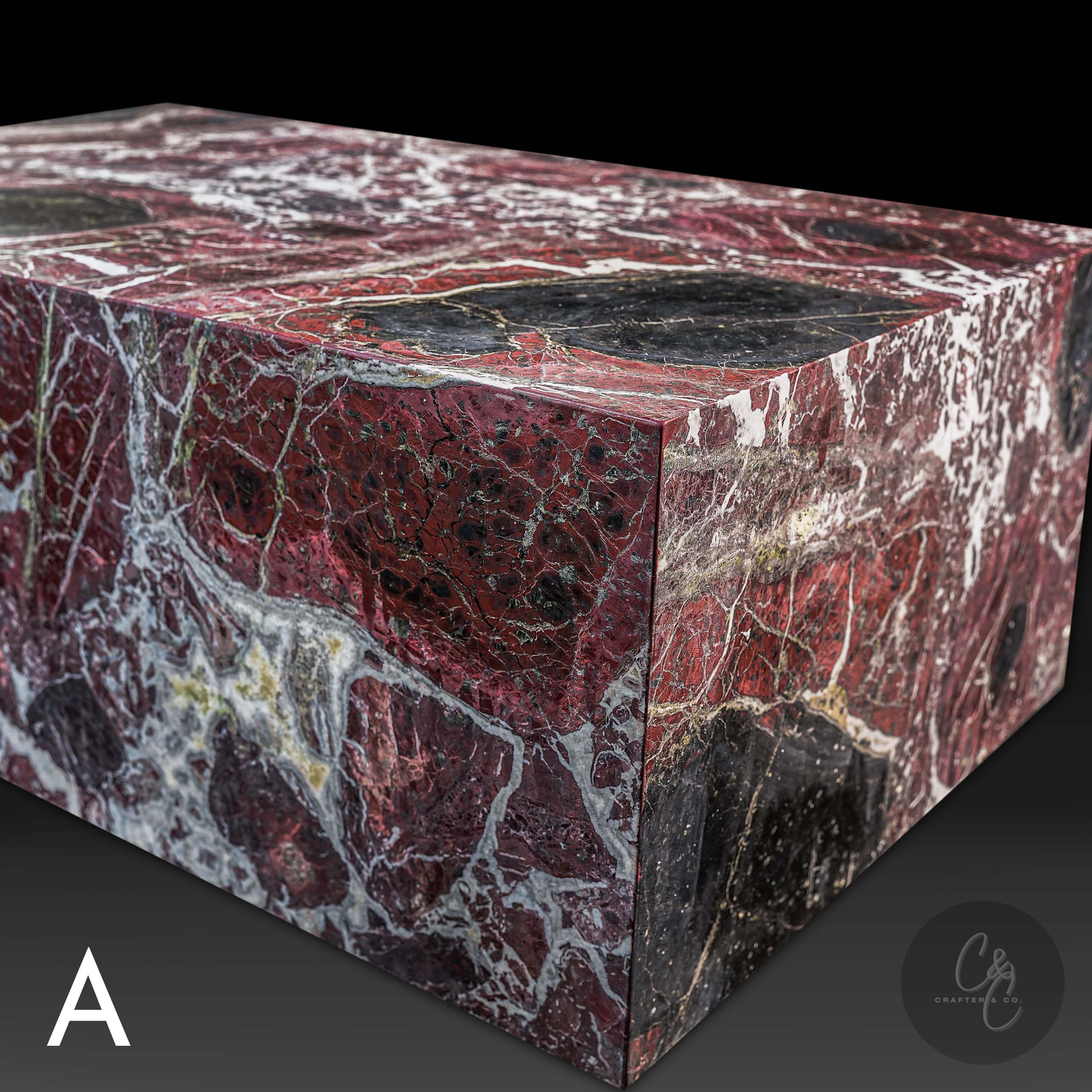 Corner detail of Small Block Rosso Levanto Marble Coffee Table showcasing deep burgundy marble with bold white veining and black accents.