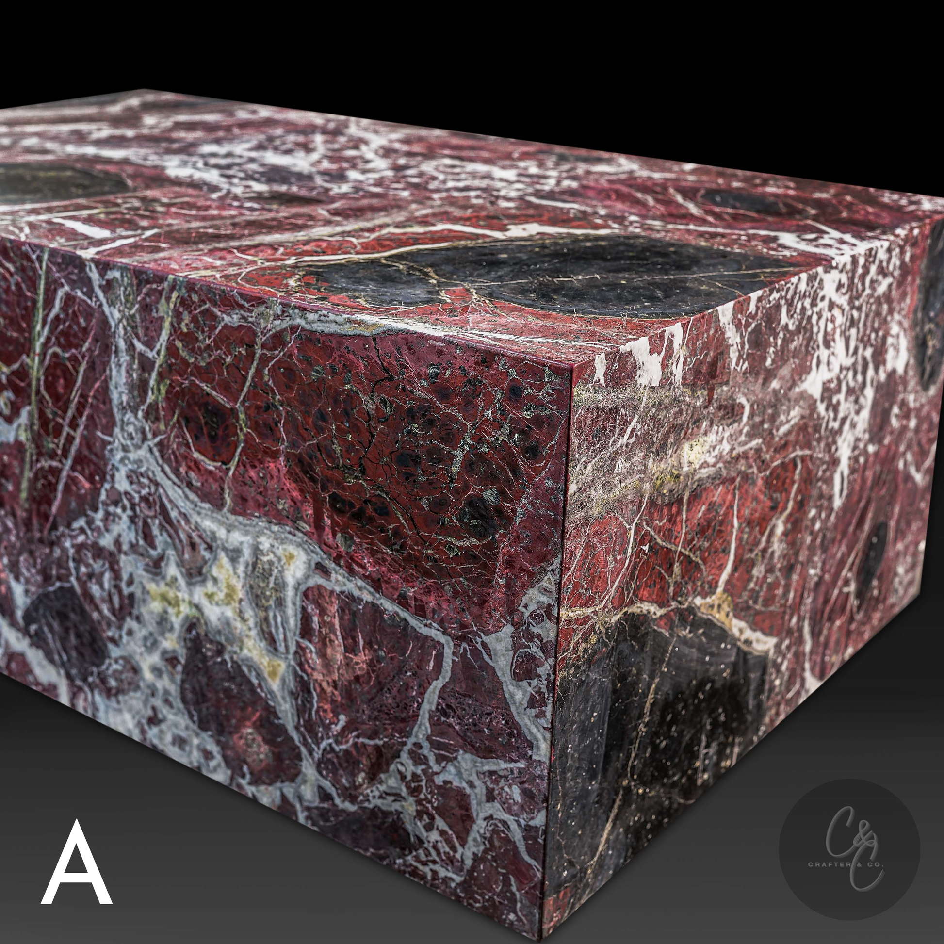 Corner detail of Small Block Rosso Levanto Marble Coffee Table showcasing deep burgundy marble with bold white veining and black accents.