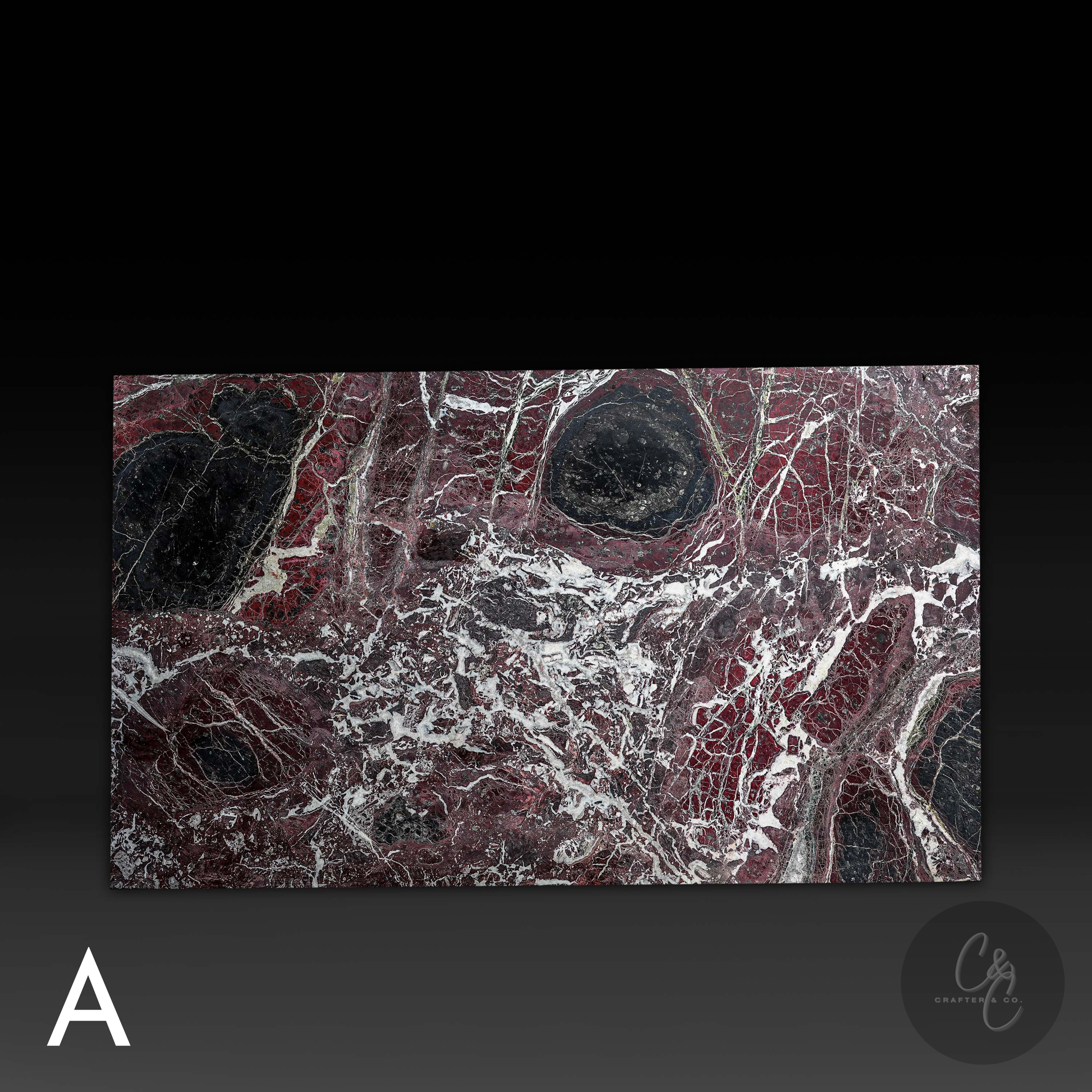 Close-up of Rosso Levanto marble top surface showing rich burgundy tones, black accents and natural white veining