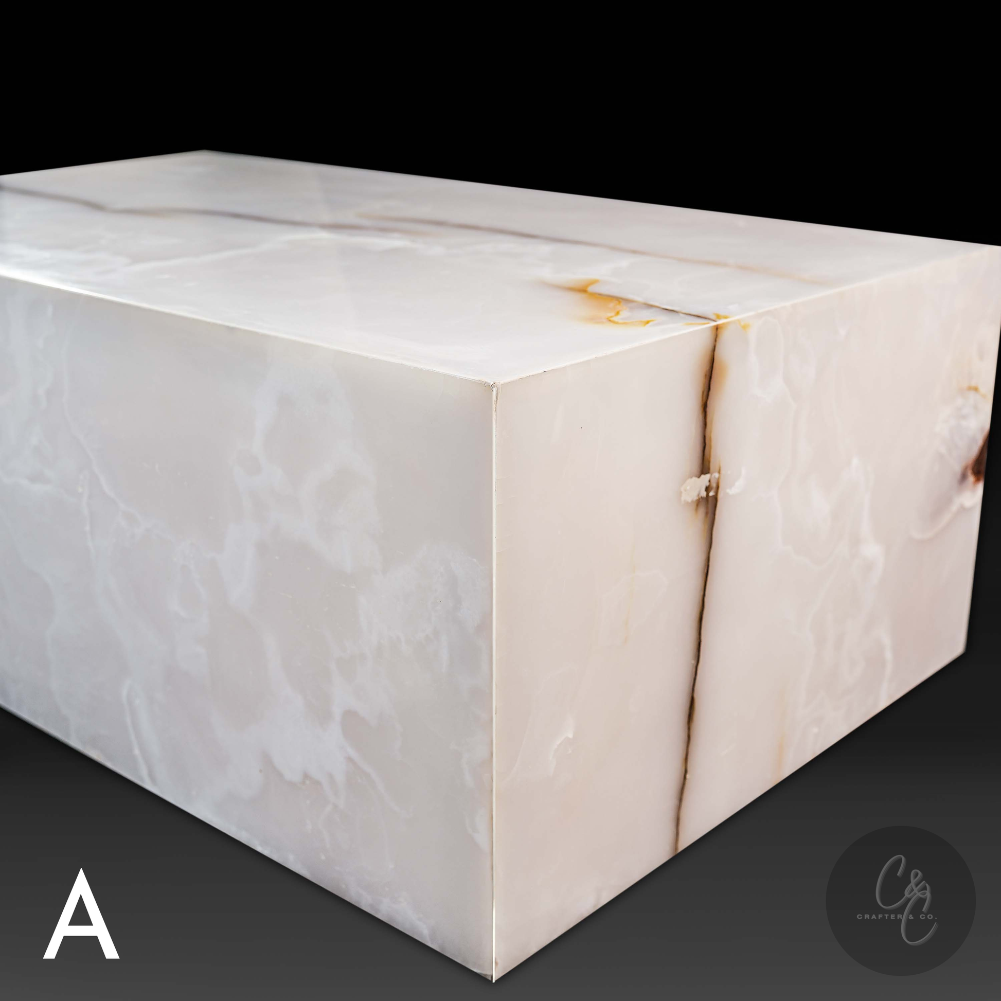 Angled view of Small Block White Onyx Coffee Table featuring natural white onyx veining and polished finish