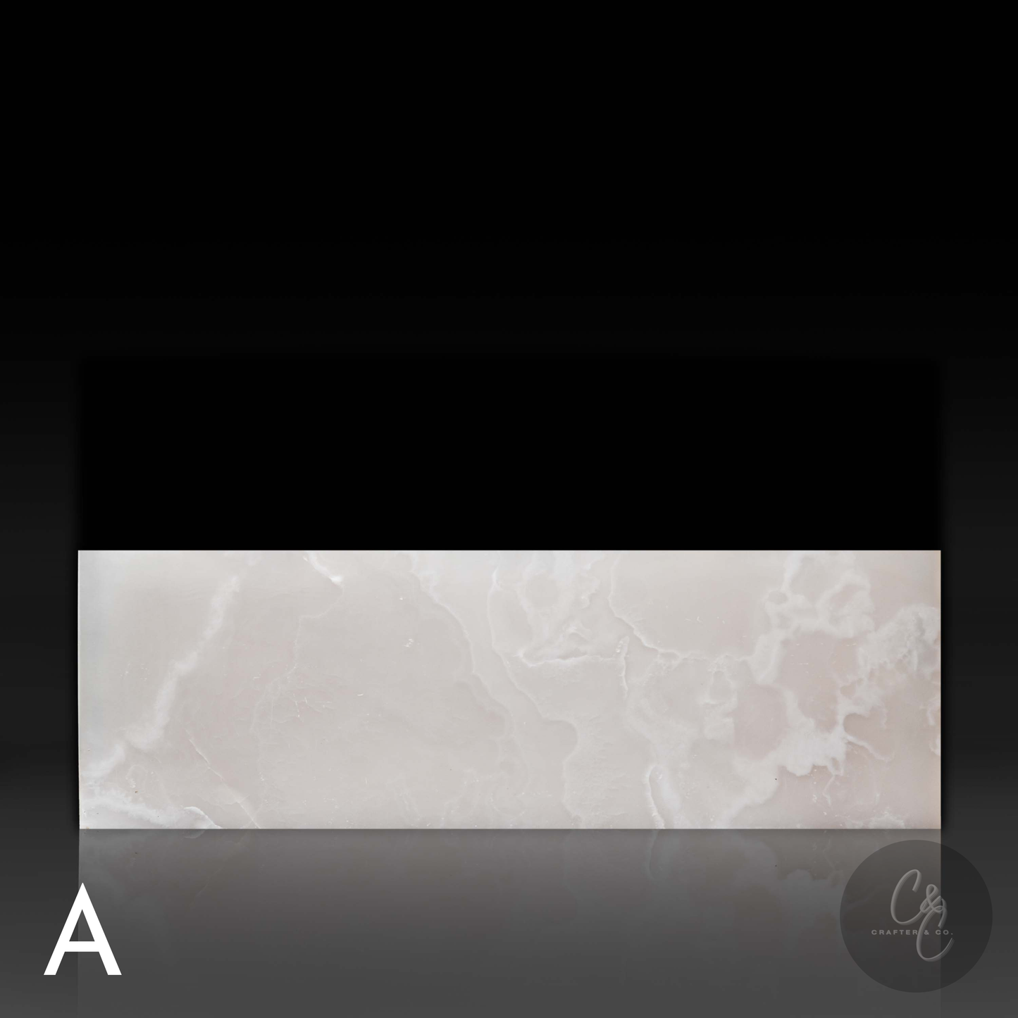 Front profile of Small Block White Onyx Coffee Table highlighting natural white onyx veining and polished finish