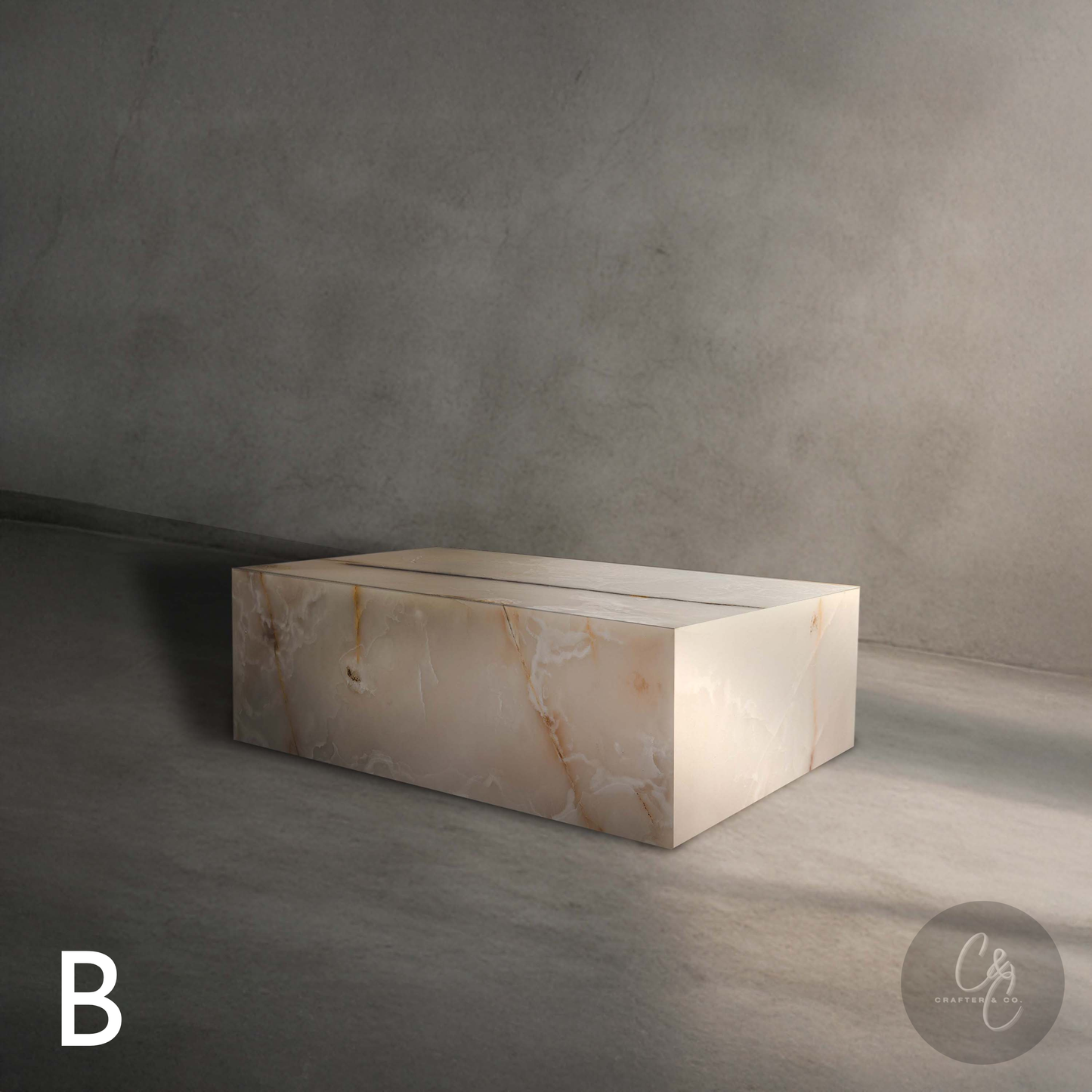 Front view of Small Block White Onyx Coffee Table Variant B featuring natural white onyx veining and polished finish