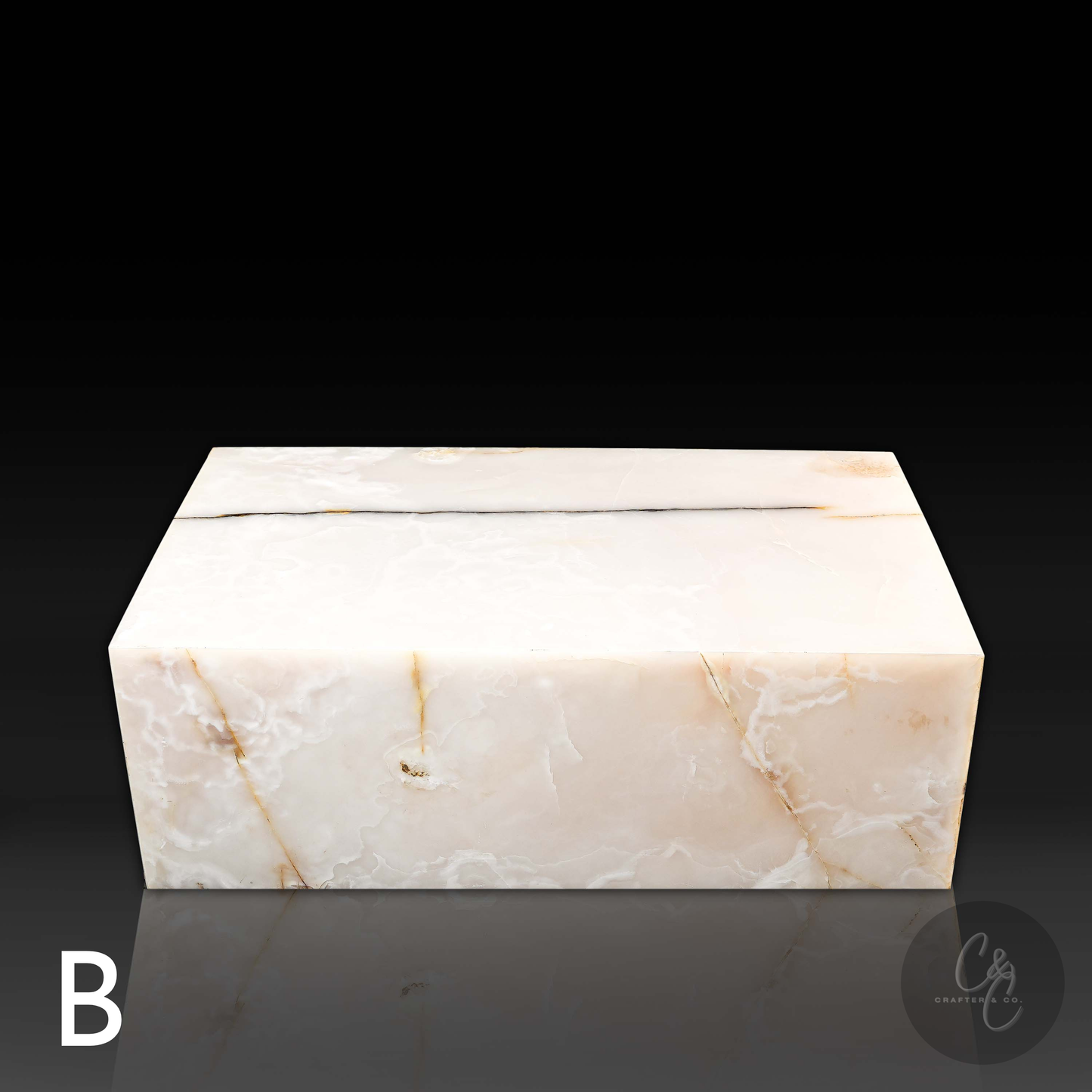 Front view of Small Block White Onyx Coffee Table Variant B in polished natural white onyx with unique ivory, gold and honey veining