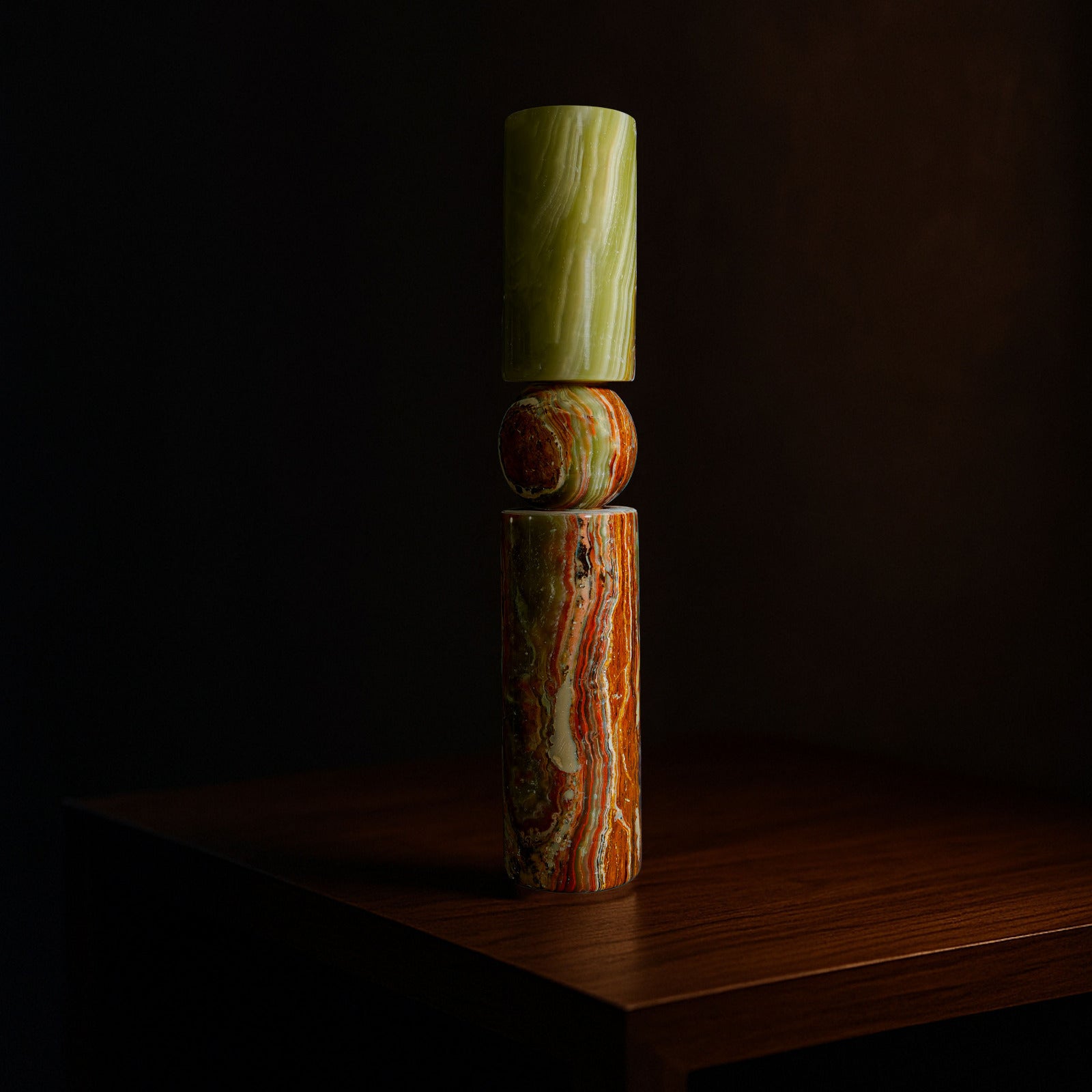 Solis natural stone candle holder in Green Onyx displayed on a timber surface.