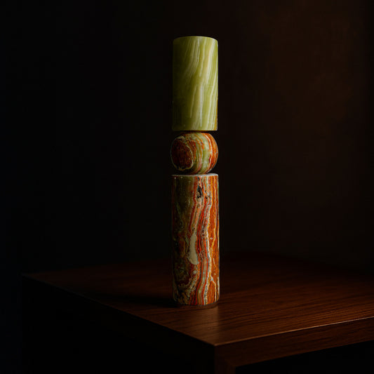 Solis natural stone candle holder in Green Onyx displayed on a timber surface.