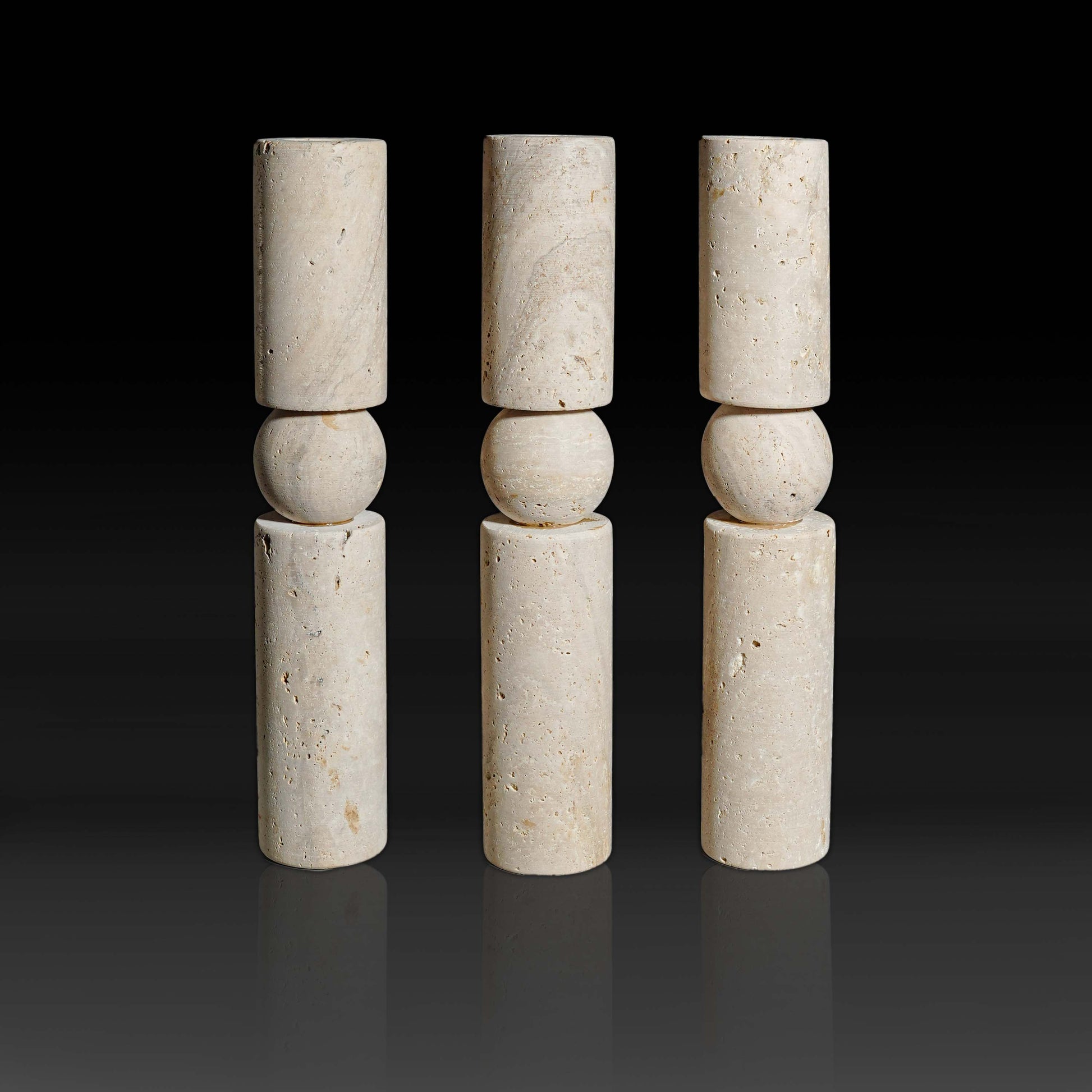 Set of three Solis Travertine natural stone candle holders showcasing warm textured travertine and sculptural design.