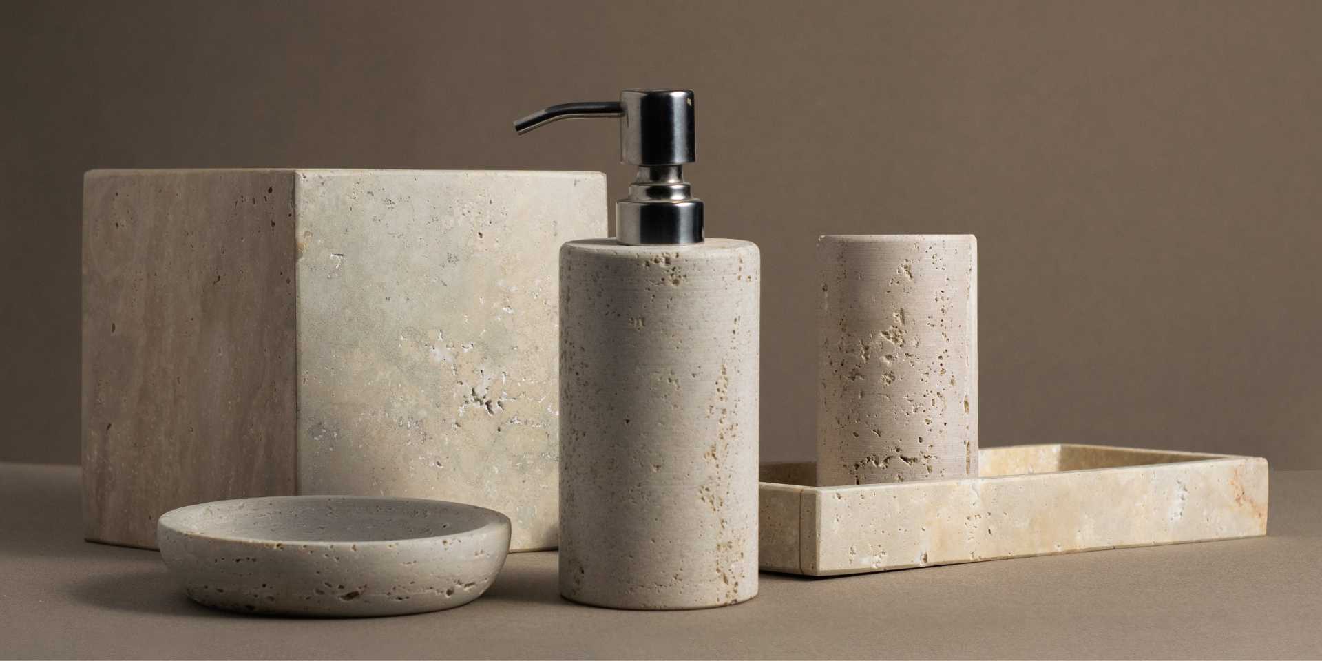 Luxury Travertine Luxe Bathroom Accessories Set featuring a travertine soap dispenser, toothbrush holder, soap dish, rectangular tray and Tissue box handcrafted from natural stone by Crafter & Co.