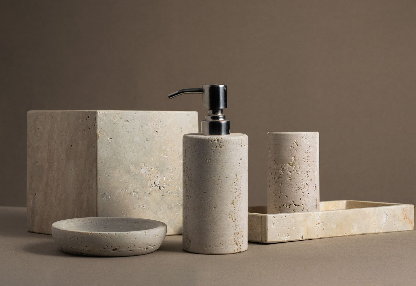 Travertine Luxe Bathroom Accessories Set with soap dispenser, tray, tumbler, tissue box and soap dish.