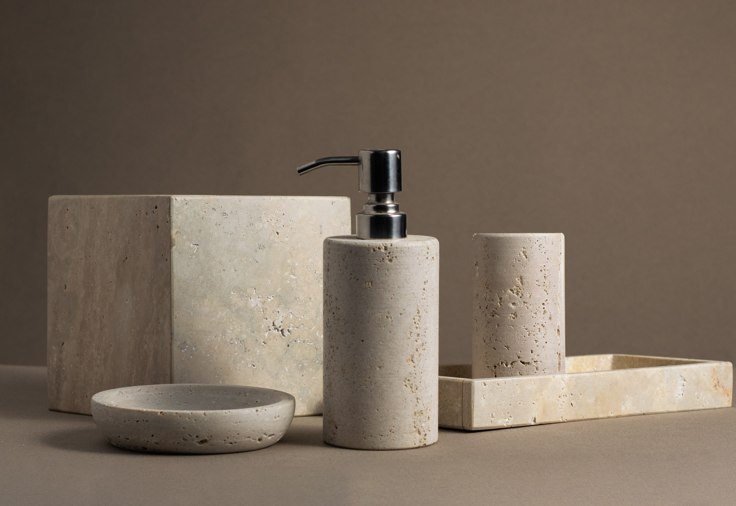 Travertine Luxe Bathroom Accessories Set with soap dispenser, tray, tumbler, tissue box and soap dish.