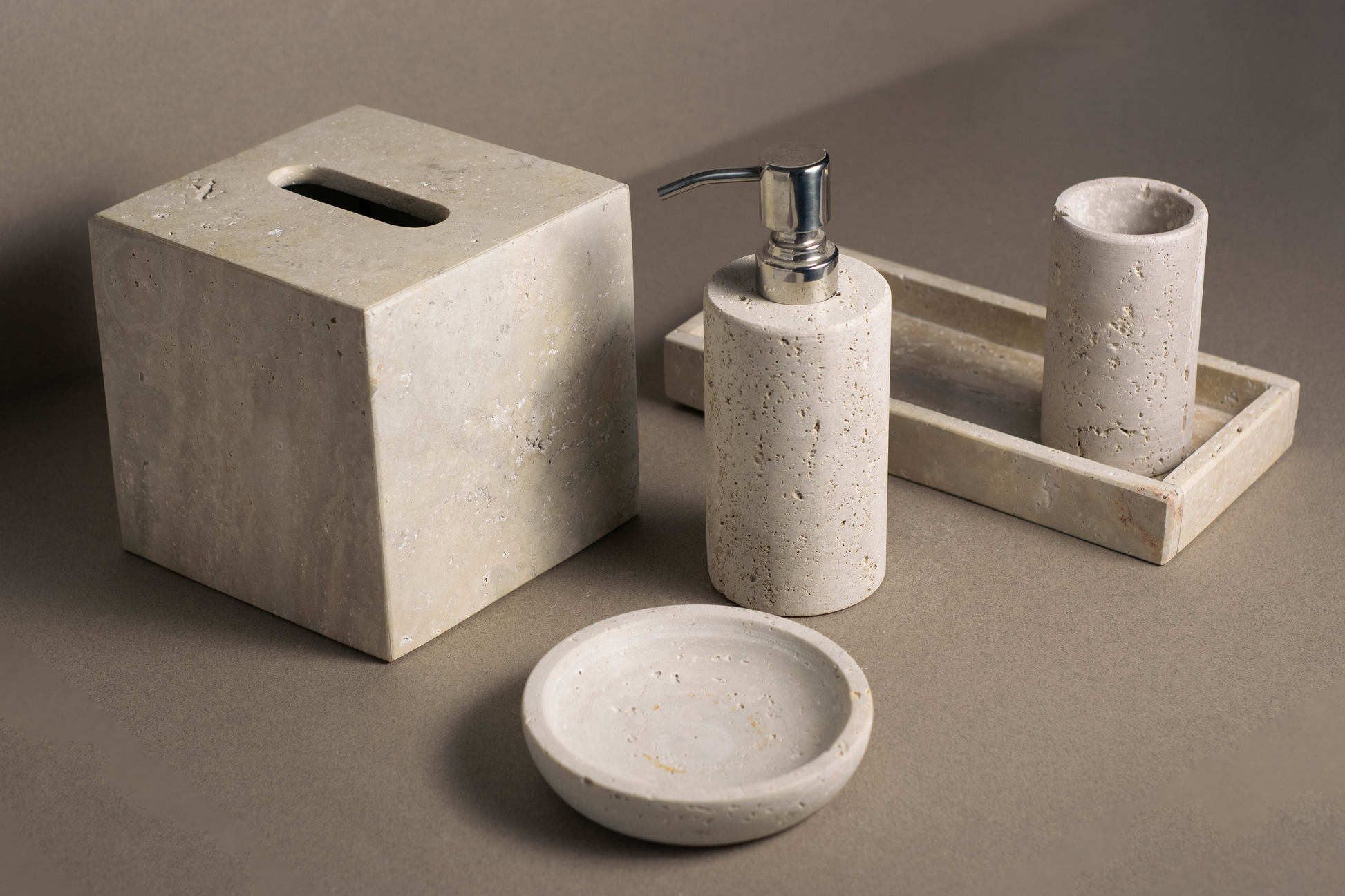 Natural travertine bathroom accessories set for modern bathroom decor.