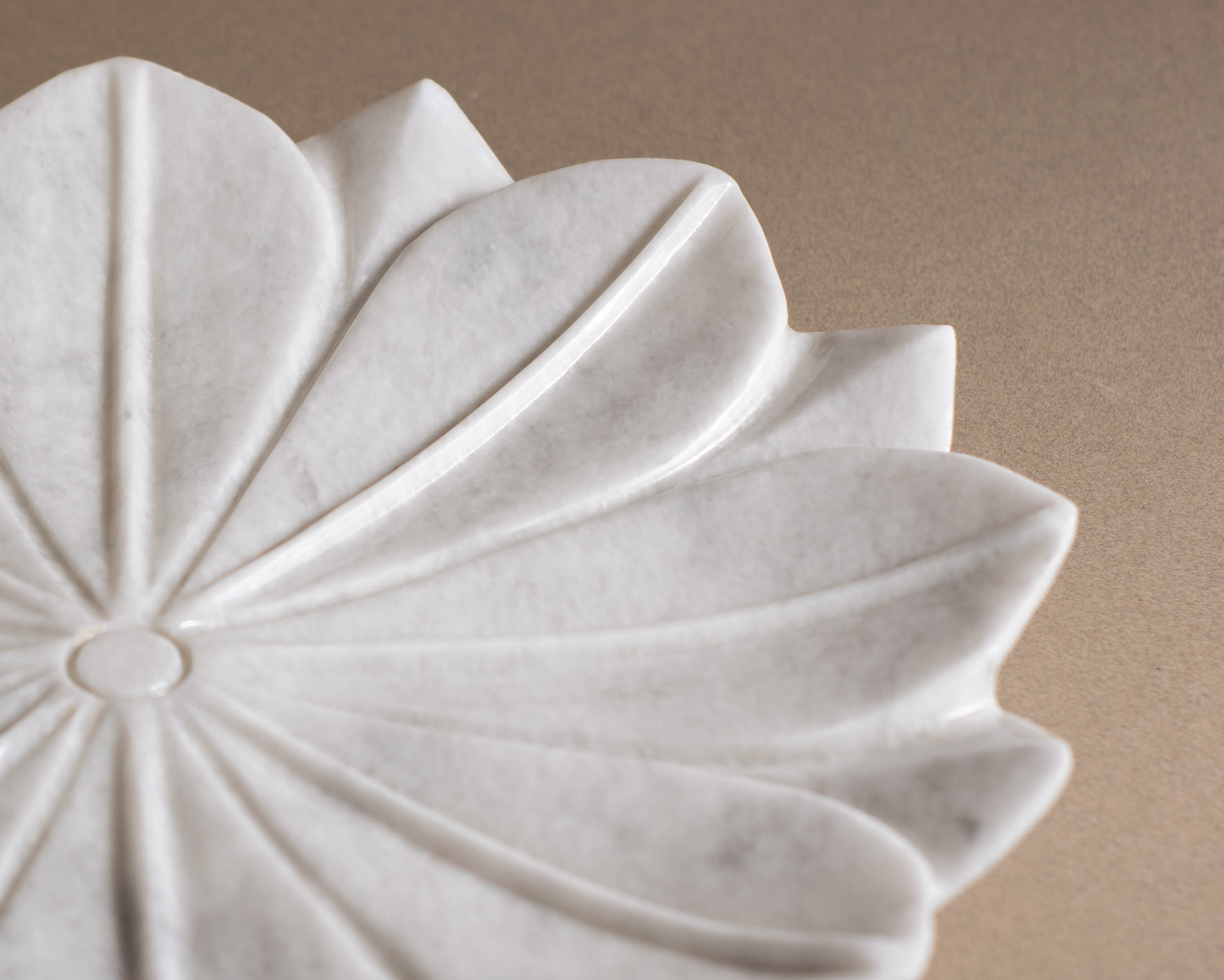 Close-up detail of the handcrafted White Marble Lotus Bowl showing natural marble veining.