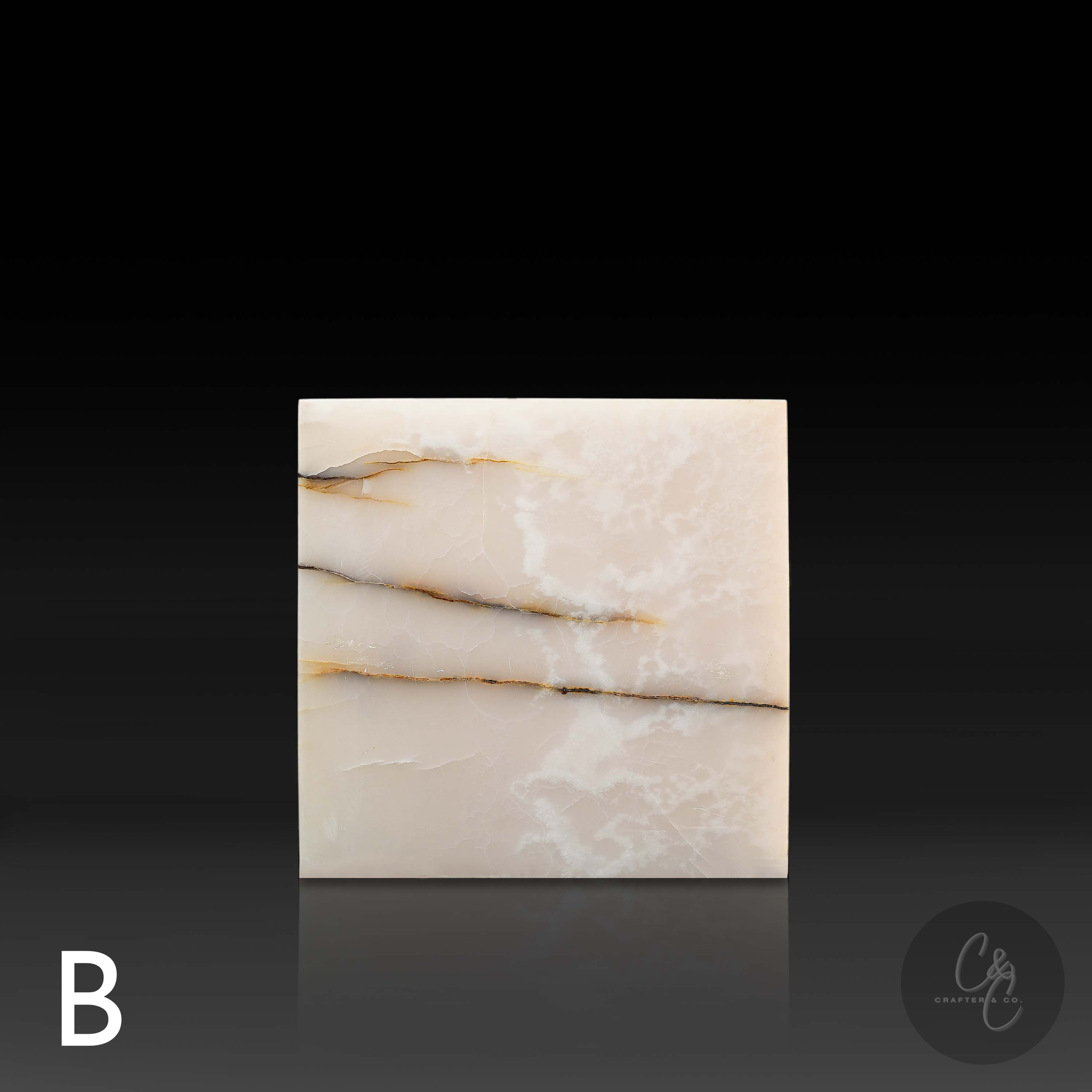 White onyx cube side table variation B shown from the front, featuring layered beige and golden natural veining.