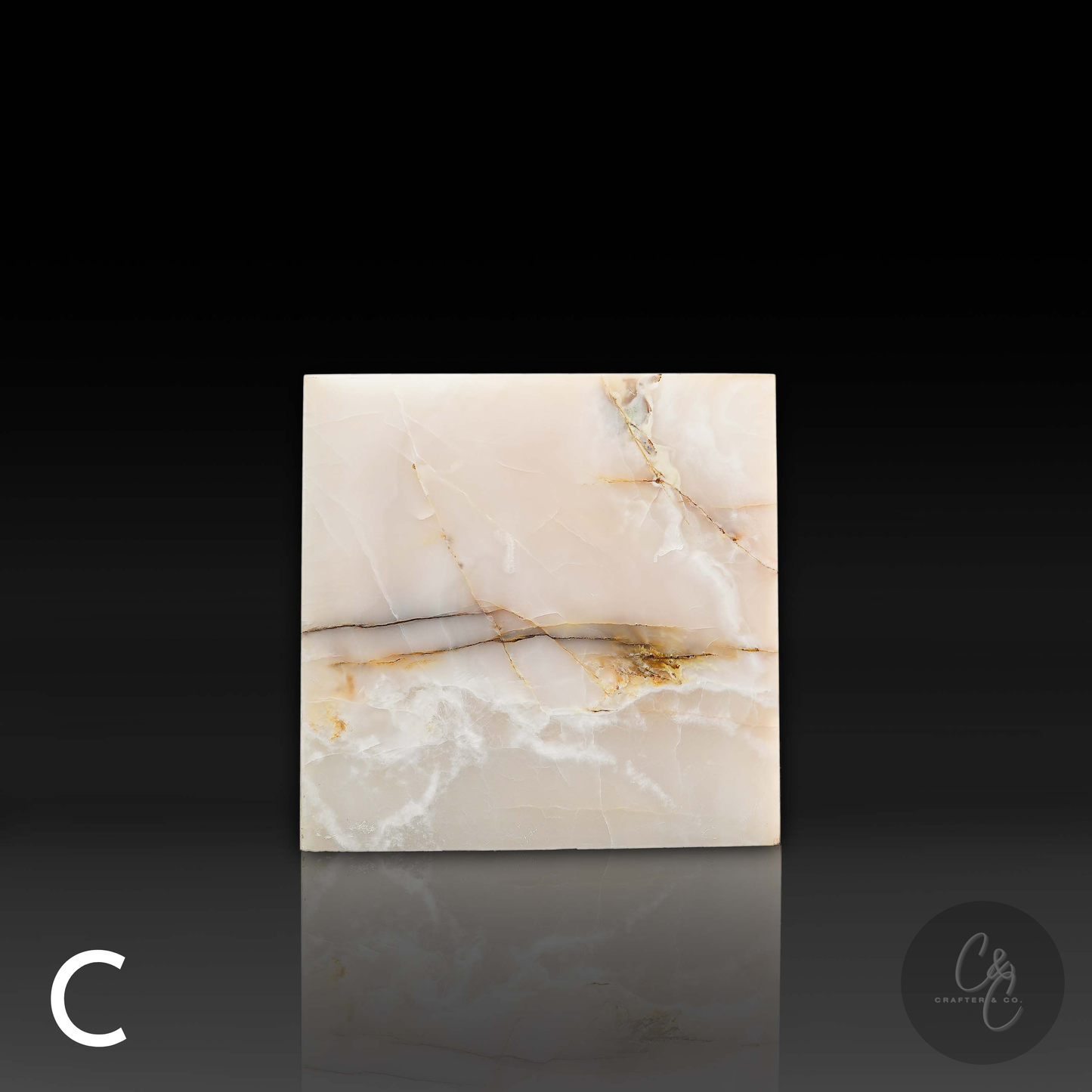 White onyx cube side table variation C shown from the front, featuring bold natural golden and grey veining.