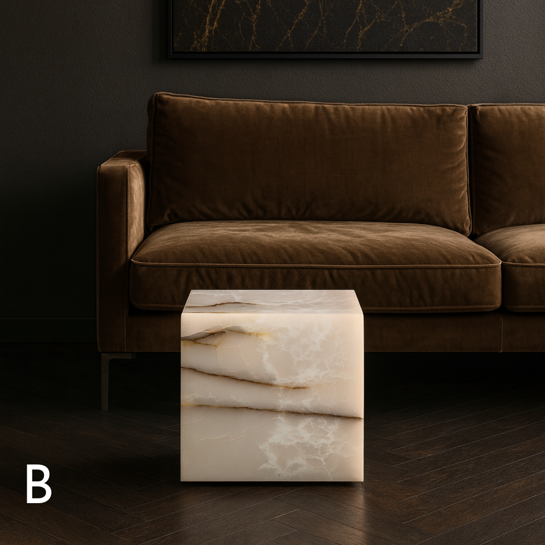 White onyx cube side table variation B styled in front of a brown velvet sofa in a refined living room.