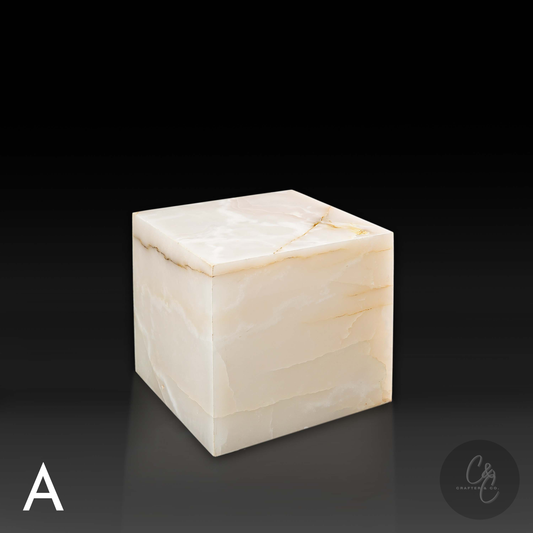 White onyx cube side table variation A shown from a top angle, highlighting its translucent surface and natural golden veining.