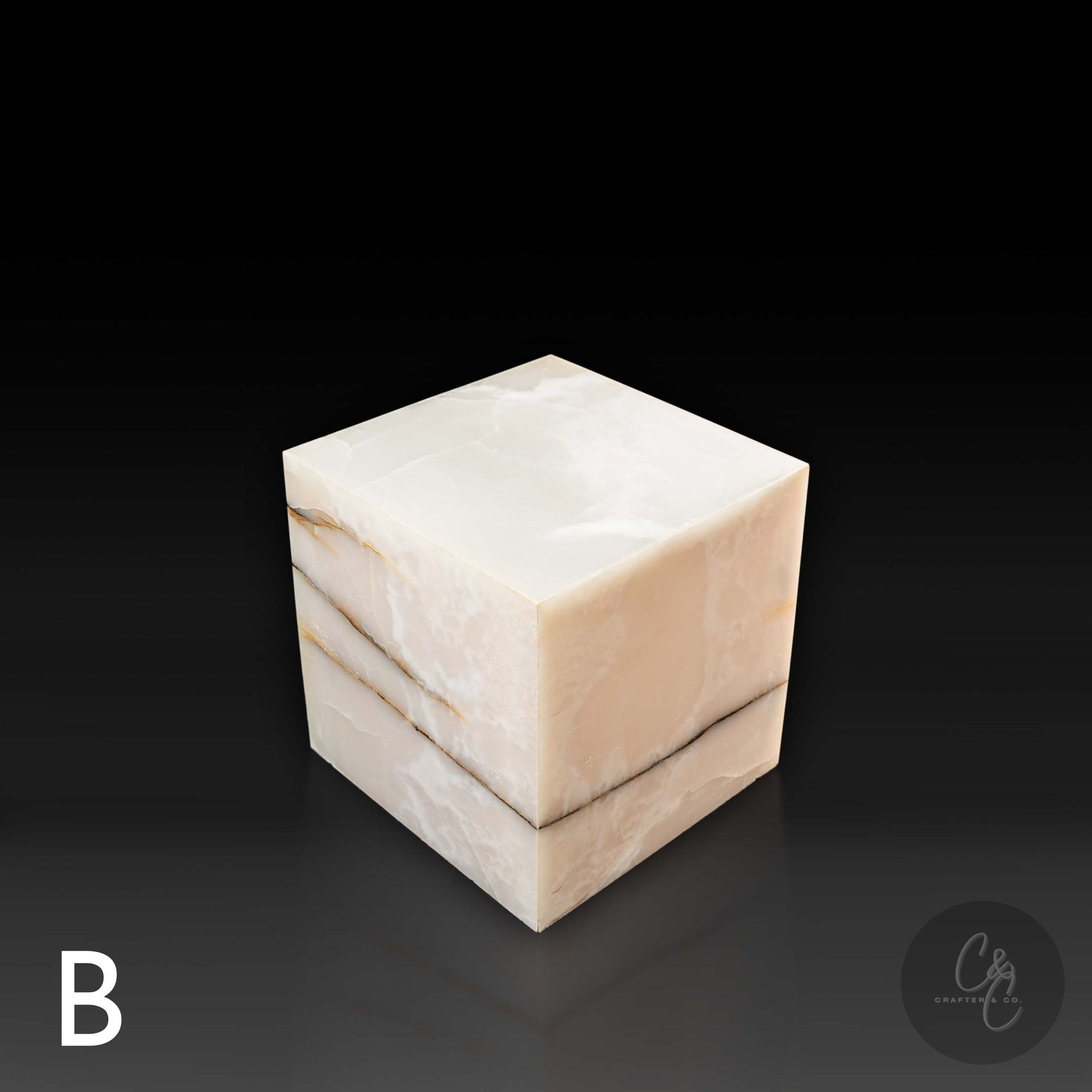 White onyx cube side table variation B shown from a top angle, highlighting its translucent surface and layered natural veining.