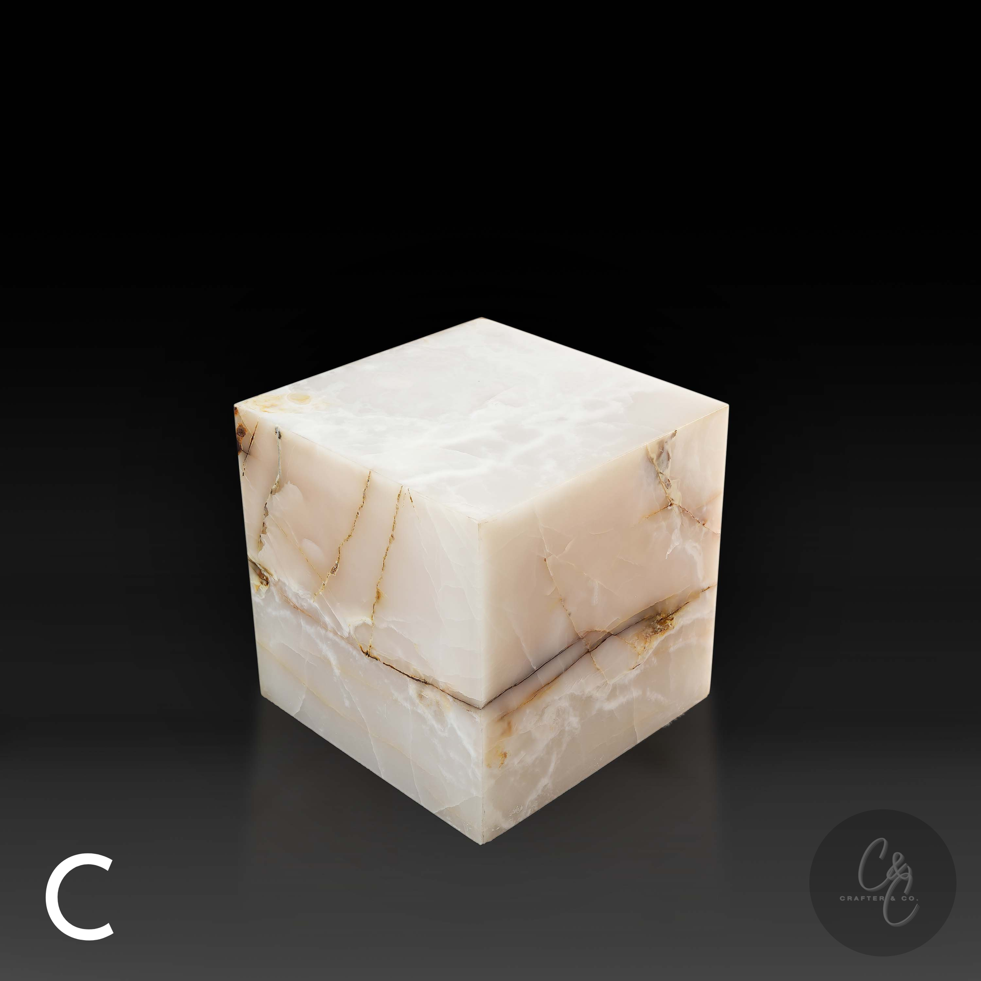 White onyx cube side table variation C shown from a top angle, highlighting its translucent surface and striking natural veining.