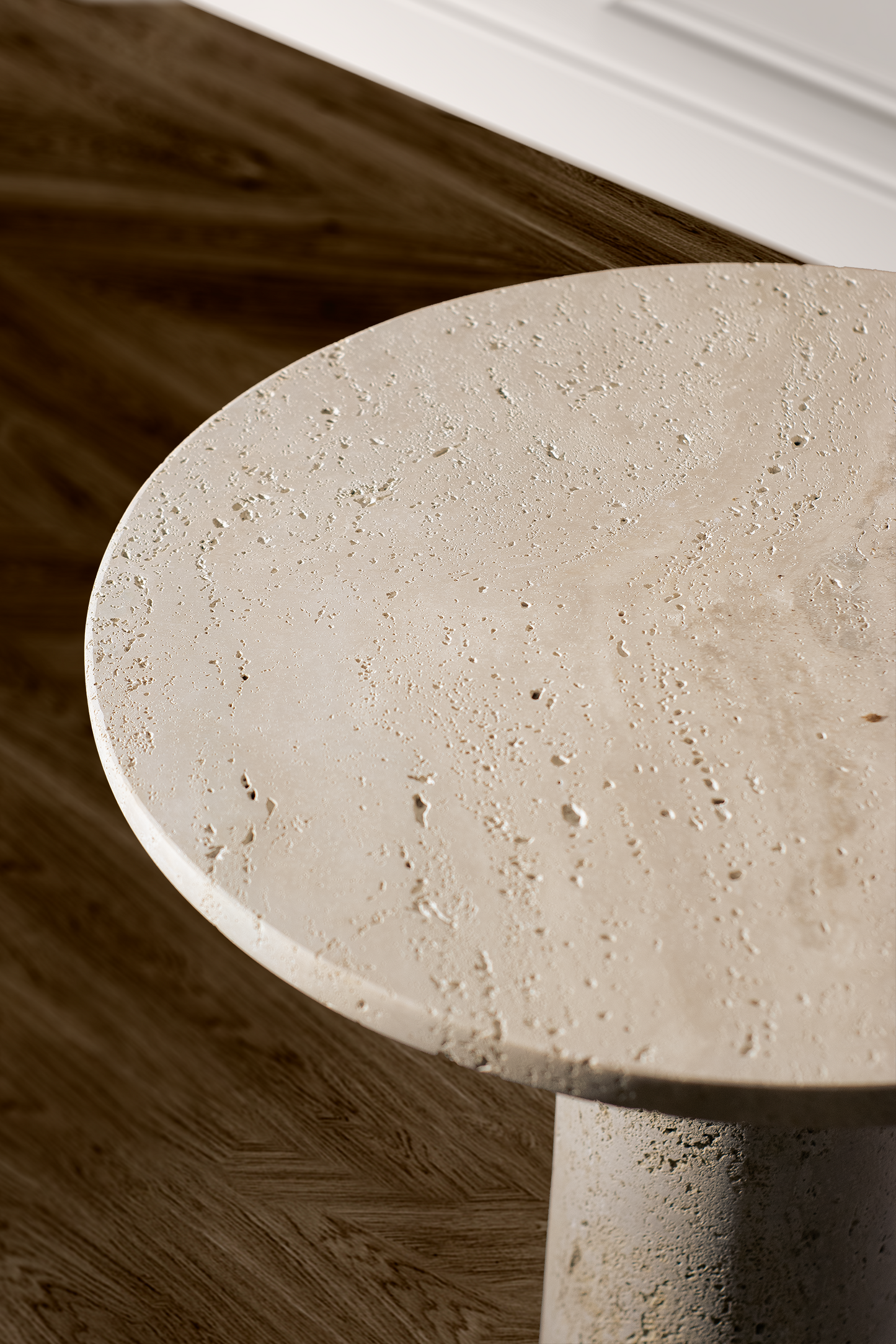 Close-up of the Zenith Travertine Side Table highlighting the natural travertine texture and honed stone. finish